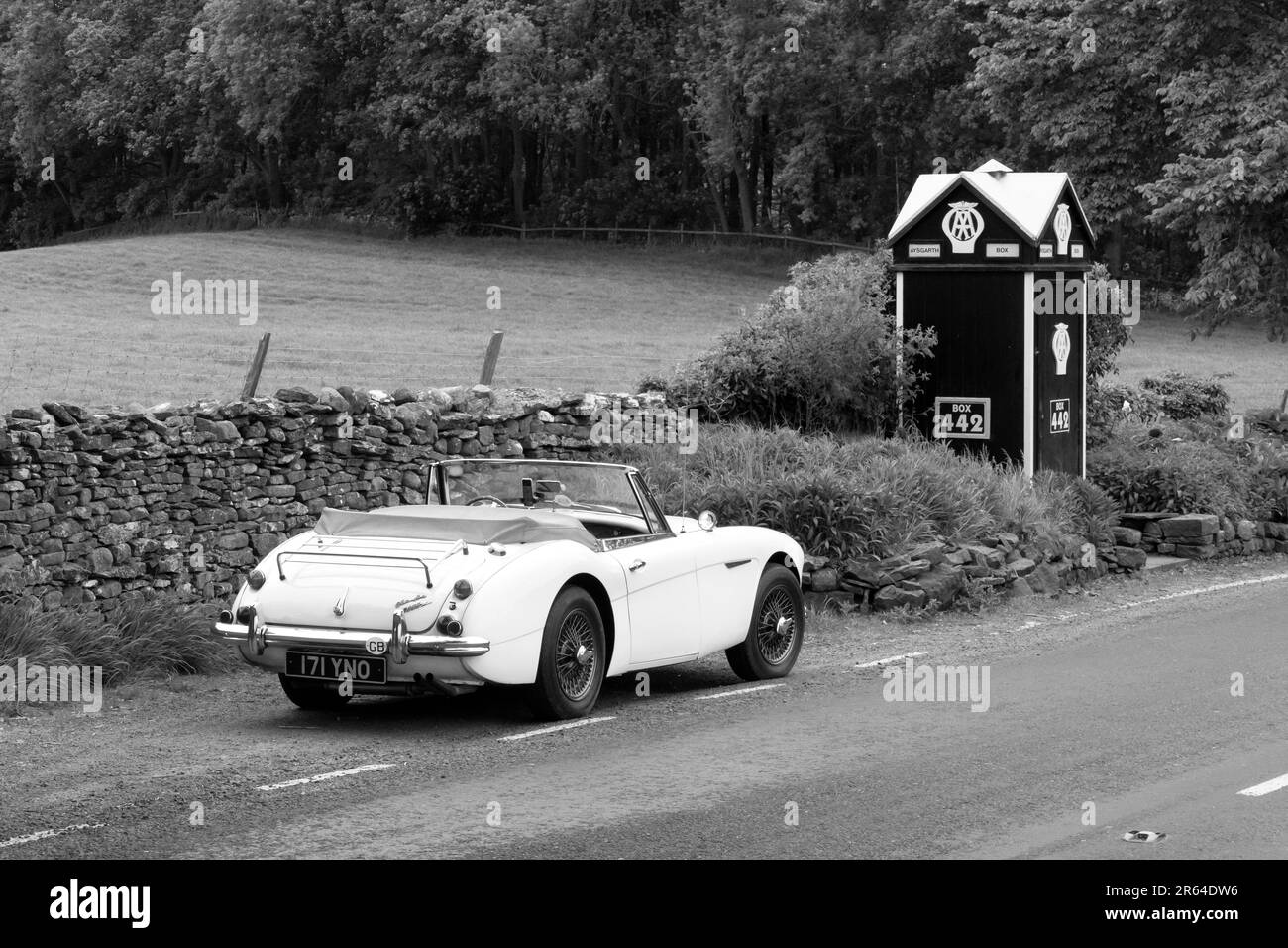 1965 Austin Healey 3000 MKIII  parked by a vintage AA box in the Yorkshire Dale UK Stock Photo