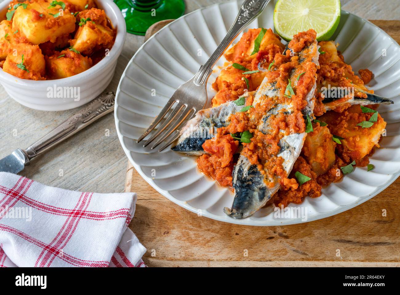Fried mackerel with spicy sauce and bomay potatoes Stock Photo