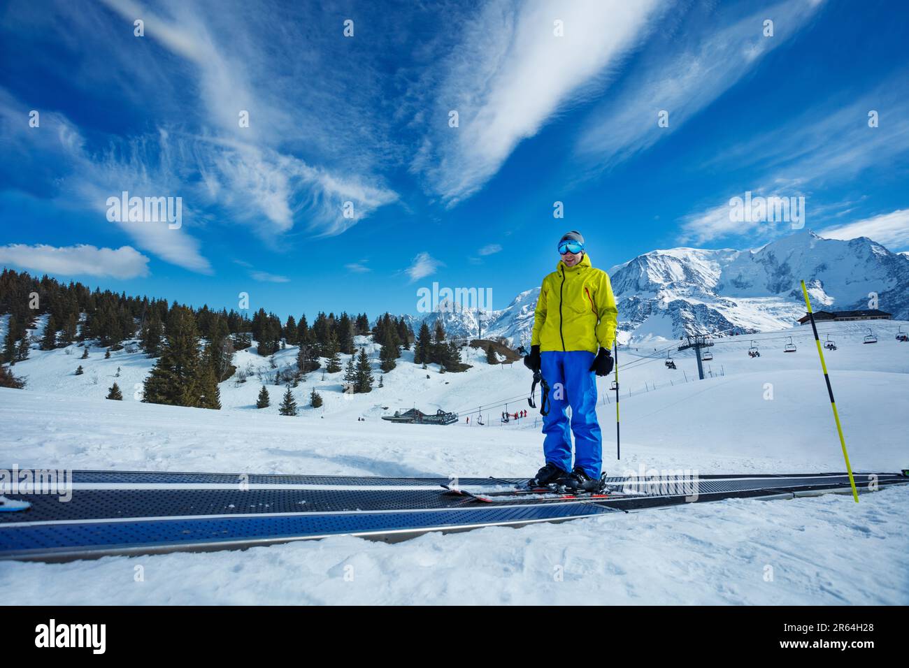 Man on moving walkway at mountain alpine ski resort Stock Photo