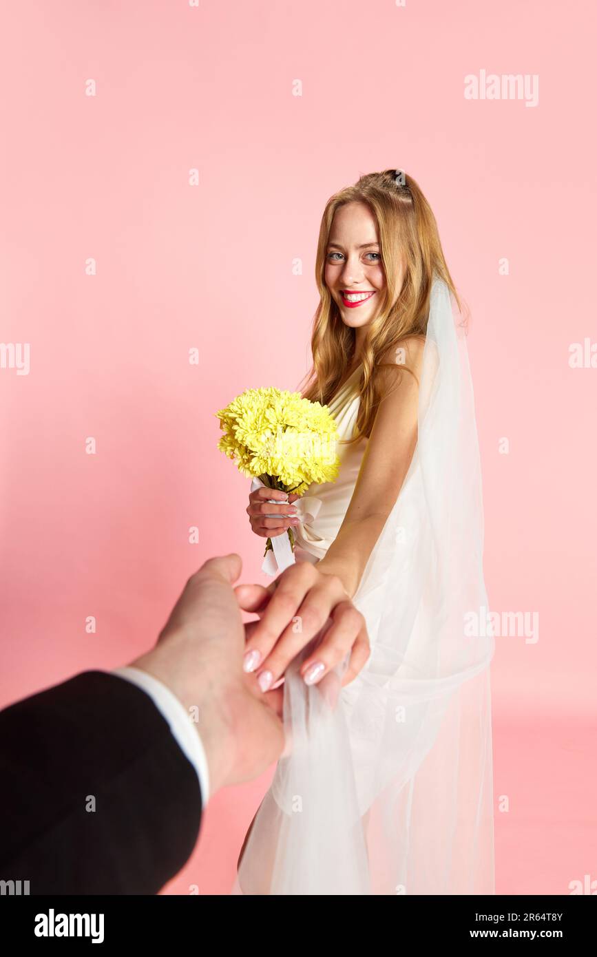 Happy wife. Portrait of beautiful, smiling young woman in white d bride ...