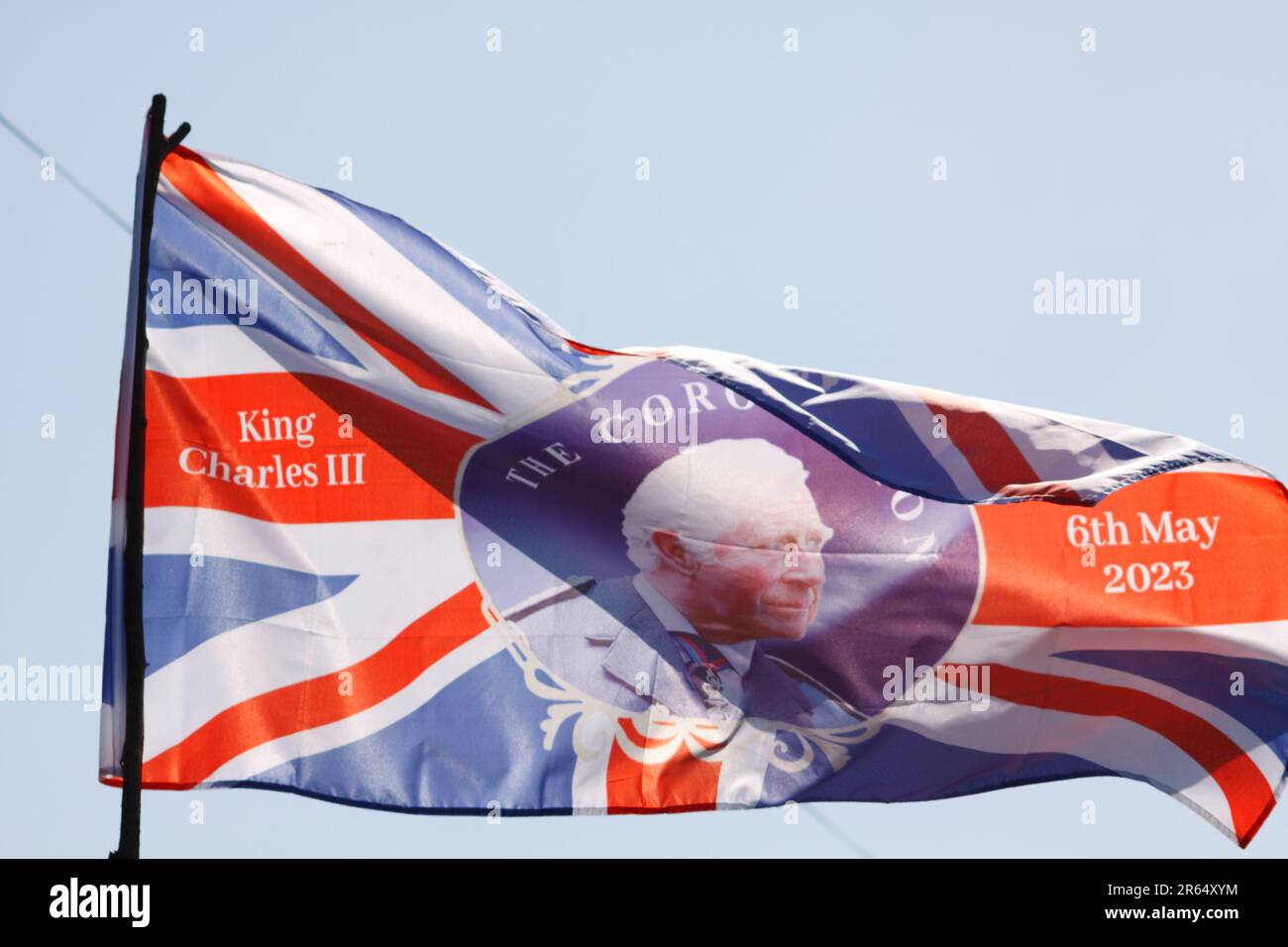 King Charles Third Coronation Flag flying in the breeze Stock Photo - Alamy