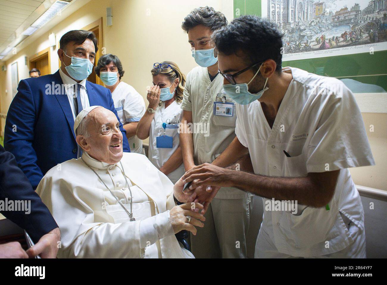 FILE Pope Francis is greeted by hospital staff as he sits in a