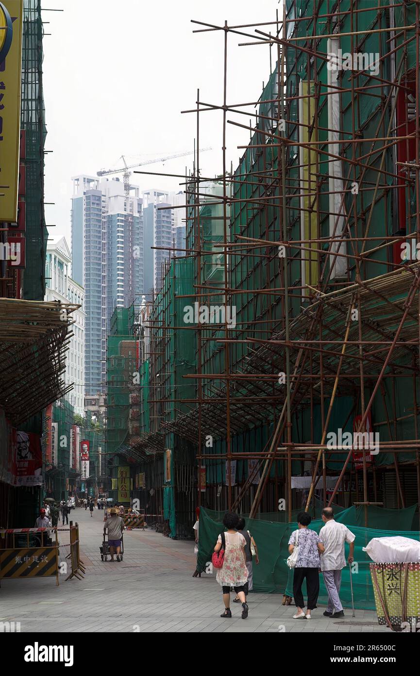 广州市 中國 Guangzhou, China; Scaffolding made of metal pipes next to a building being renovated; Gerüst aus Metallrohren neben einem Gebäude Stock Photo