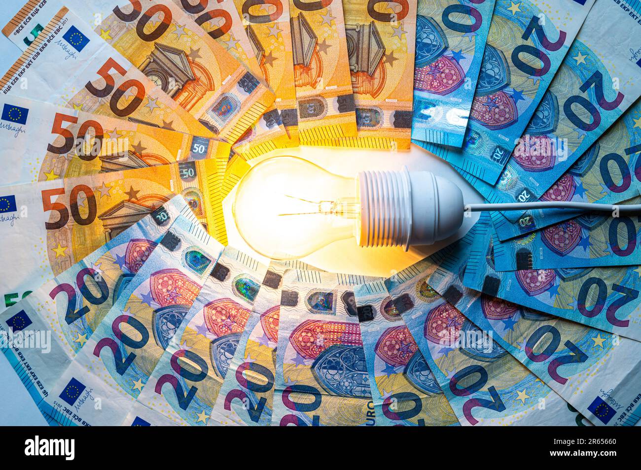 Light bulb turned on, with Euro banknotes around. Increase in