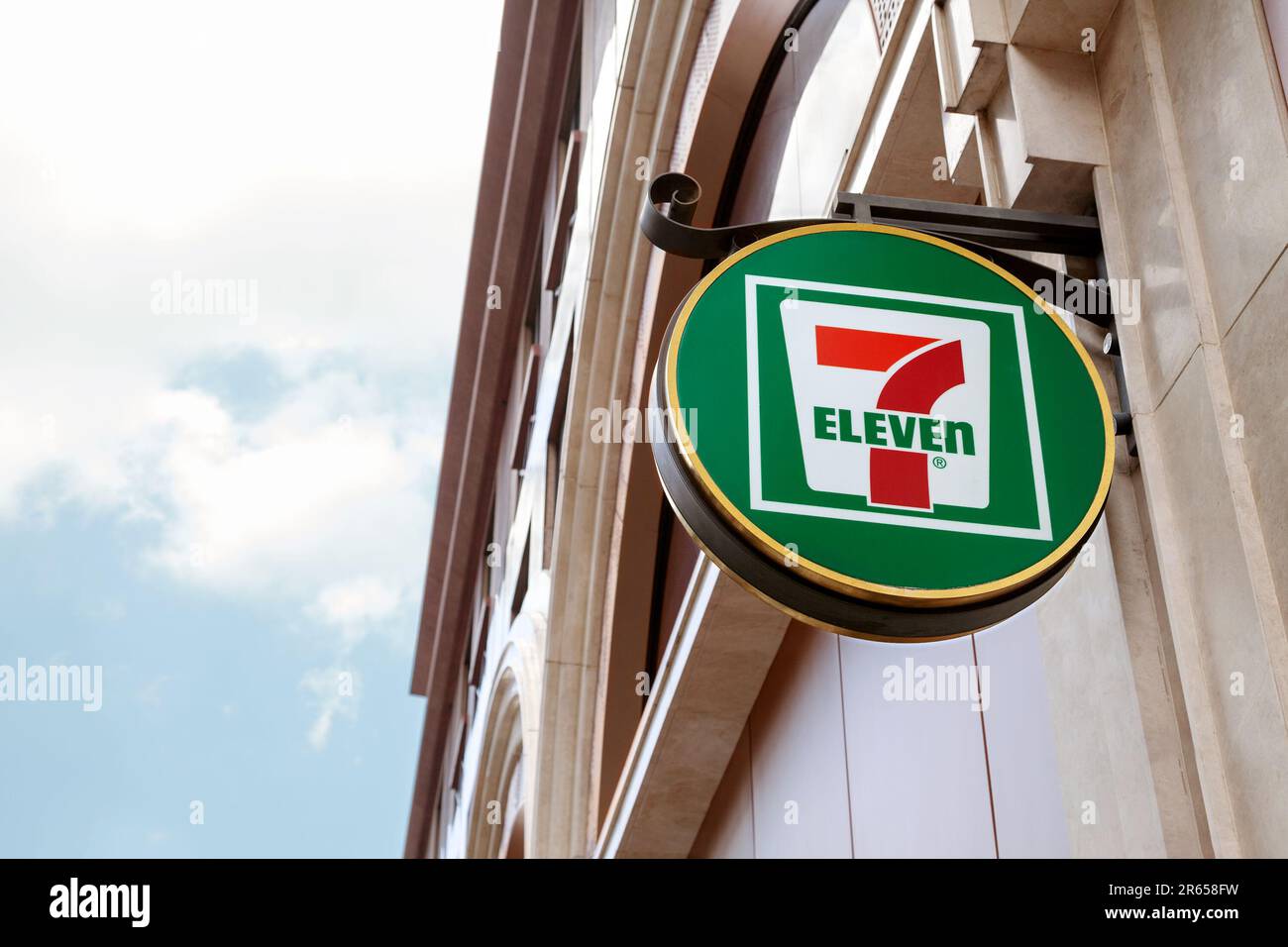 Ho Chi Minh City, Vietnam - June 4, 2023: Green and red information sign with 7-eleven logo on a convenience store. Lightbox advertisement outside a g Stock Photo