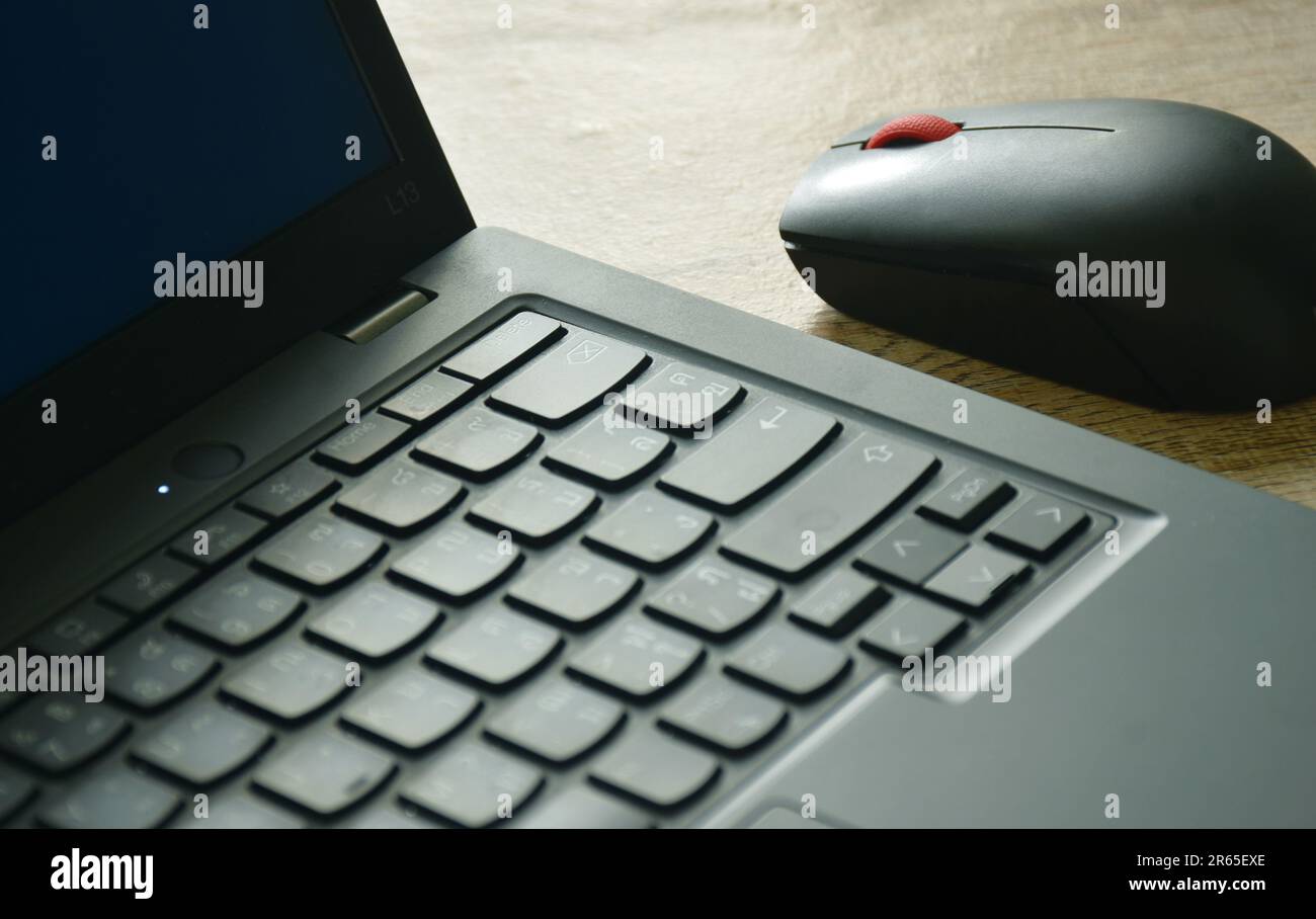 laptop and computer mouse on wooden table Stock Photo