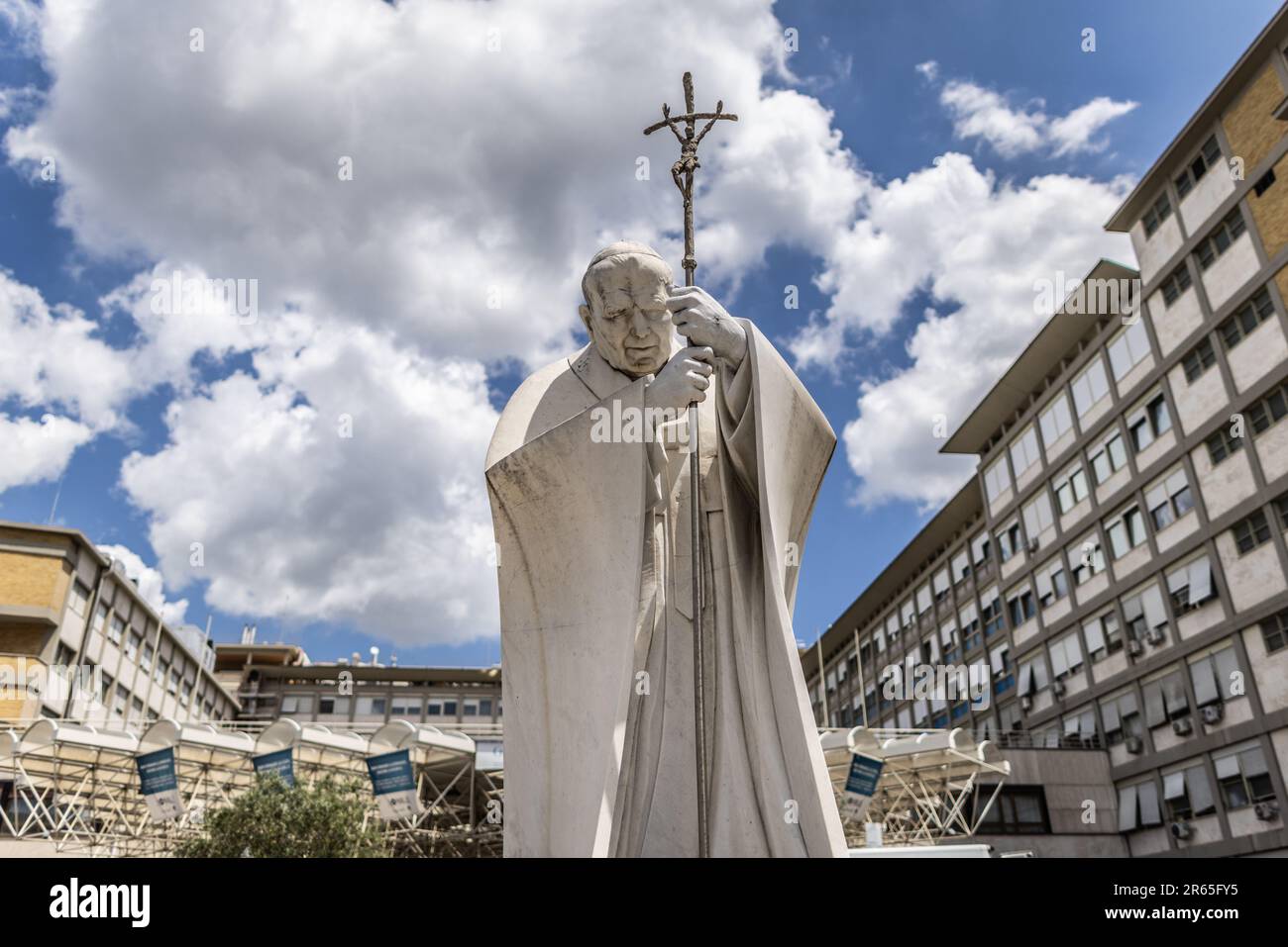 Rome, Italy. 07th June, 2023. A statue of late Pope John Paul II. is backdropped by the Gemelli Hospital, where Pope Francis undergoes abdominal surgery, in Rome. Pope Francis, 86, must undergo an urgent operation on Wednesday afternoon to repair a hernia in his abdominal area and will be hospitalized for 'several days,' the Holy See announced on Wednesday. Credit: Oliver Weiken/dpa/Alamy Live News Stock Photo