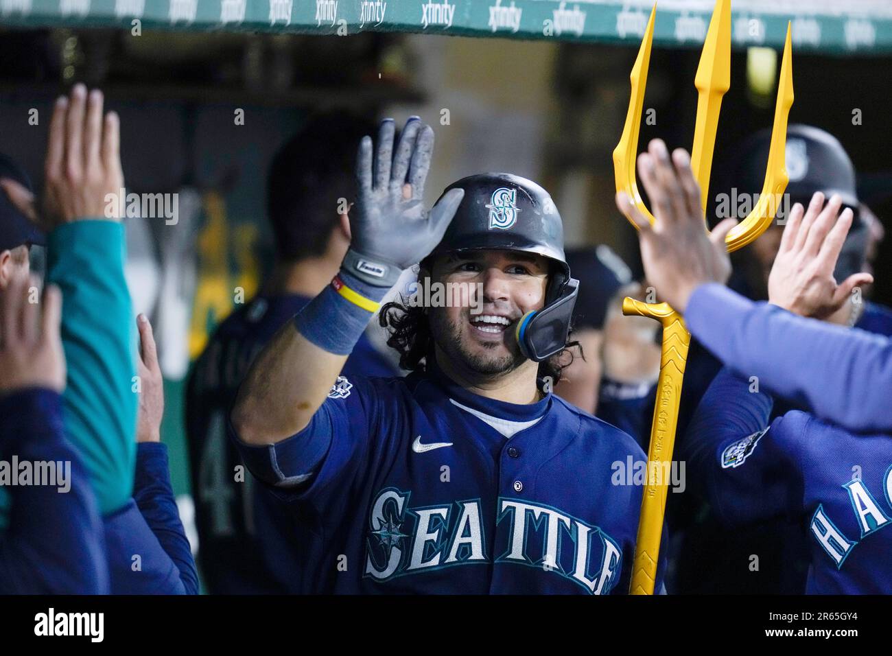 Seattle Mariners' Eugenio Suarez holds a trident as he celebrates