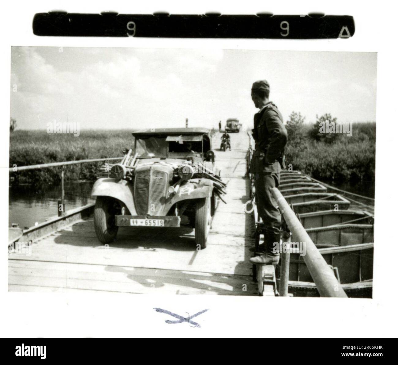 SS Photographer Baumann, Totenkopf Division, Russia 1941 Wheeled reconnaissance unit , photos of motorcycles, flak guns, graves, Russian prisoners of war and villagers, Fieseler Fi 156 Storch, destroyed Russian tanks and equipment, bridge building, soldiers swimming in river, machine gun crew, anti-tank gun crew, unit awards ceremony, units on the march, artillery towed by halftracks, motor vehicle maintenance unit, Kriegsberichter activities, field bakery, field hospital, air resupply by JU-52, antiaircraft searchlight unit, field post office, and a  Focke-Wulf 189 (Eagle-Owl) in flight.  Ima Stock Photo