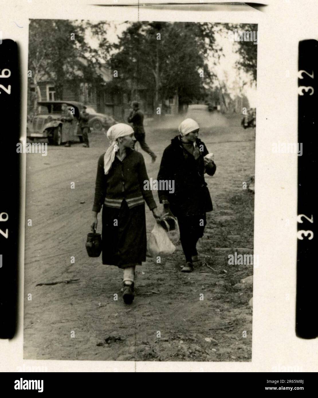 SS Photographer Baumann, Totenkopf Division, Russia 1941 Wheeled reconnaissance unit , photos of motorcycles, flak guns, graves, Russian prisoners of war and villagers, Fieseler Fi 156 Storch, destroyed Russian tanks and equipment, bridge building, soldiers swimming in river, machine gun crew, anti-tank gun crew, unit awards ceremony, units on the march, artillery towed by halftracks, motor vehicle maintenance unit, Kriegsberichter activities, field bakery, field hospital, air resupply by JU-52, antiaircraft searchlight unit, field post office, and a  Focke-Wulf 189 (Eagle-Owl) in flight.  Ima Stock Photo