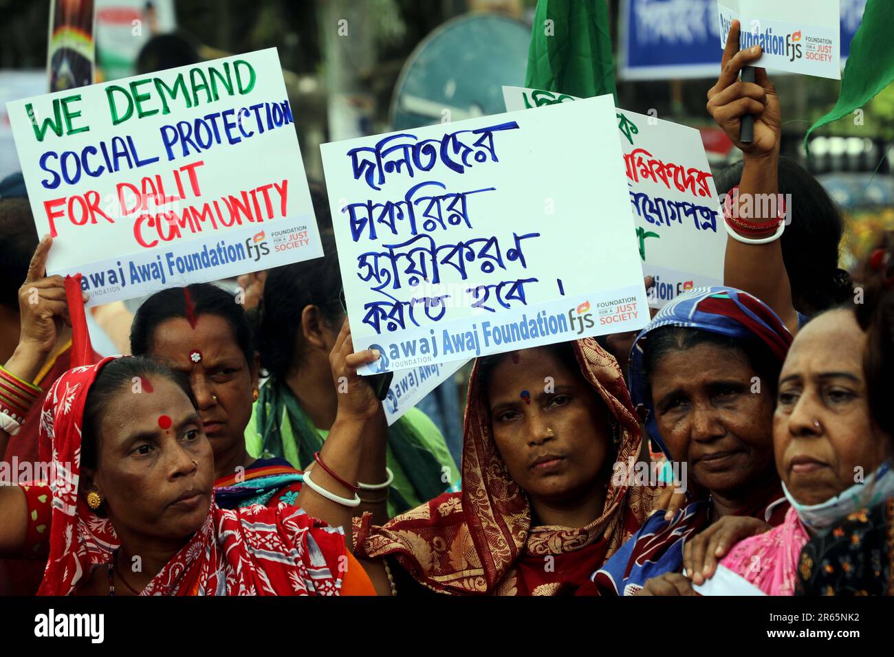 DHAKA, BANGLADESH - JUNE 2: Dalit and excluded community members hold signs and chant as they participate in a protest demanding human rights in front Stock Photo