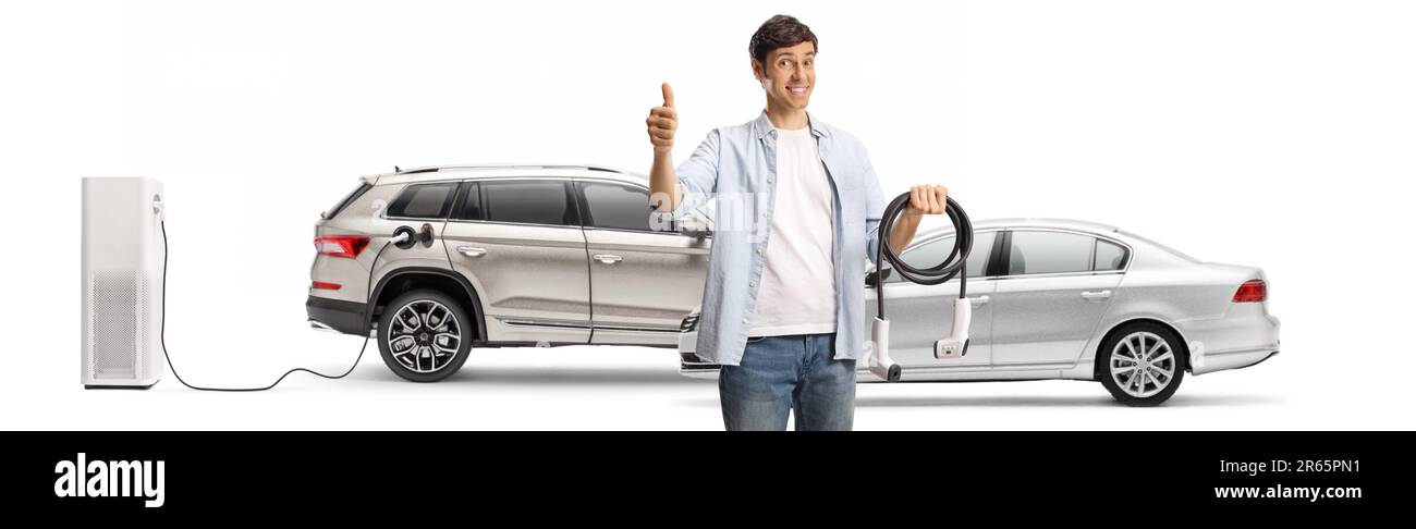 Man with a ev charger and cars gesturing thumbs up isolated on white background Stock Photo