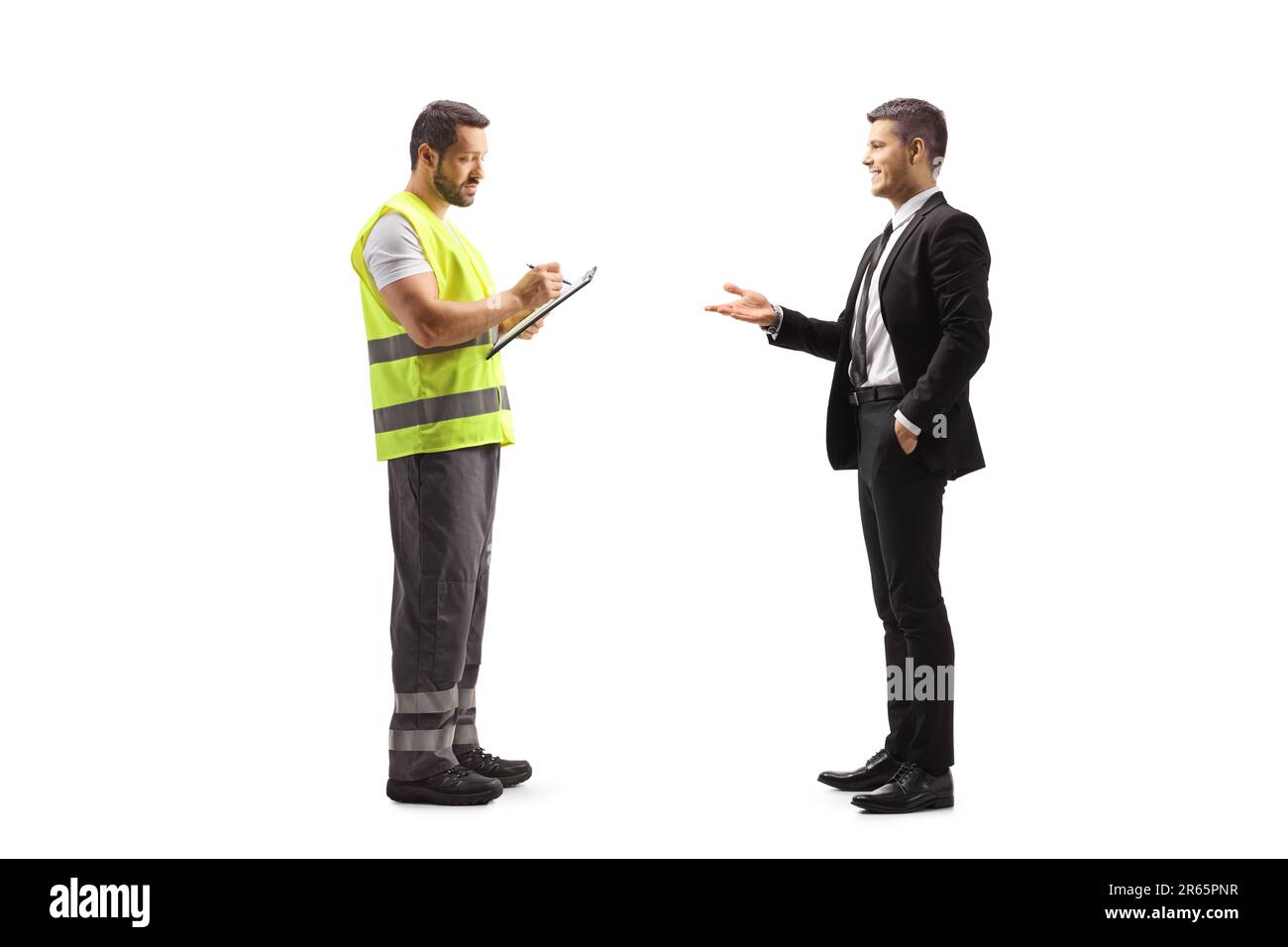 Road assistance worker in a reflective vest writing a document and talking to a businessman isolated on white background Stock Photo