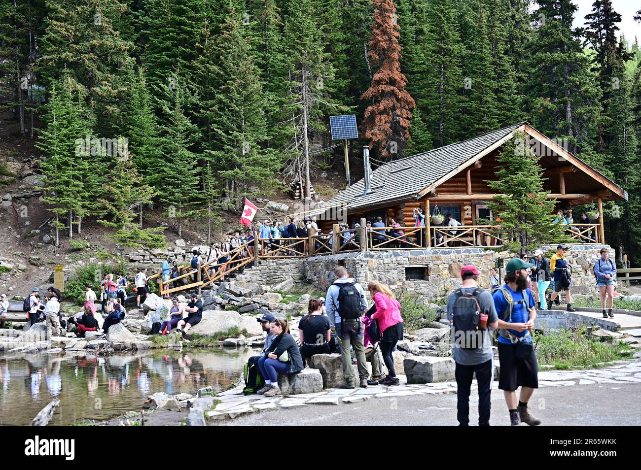 Hikers line up at the Tea House at the top of Lake Agnes Trail in Alberta, Canada Stock Photo