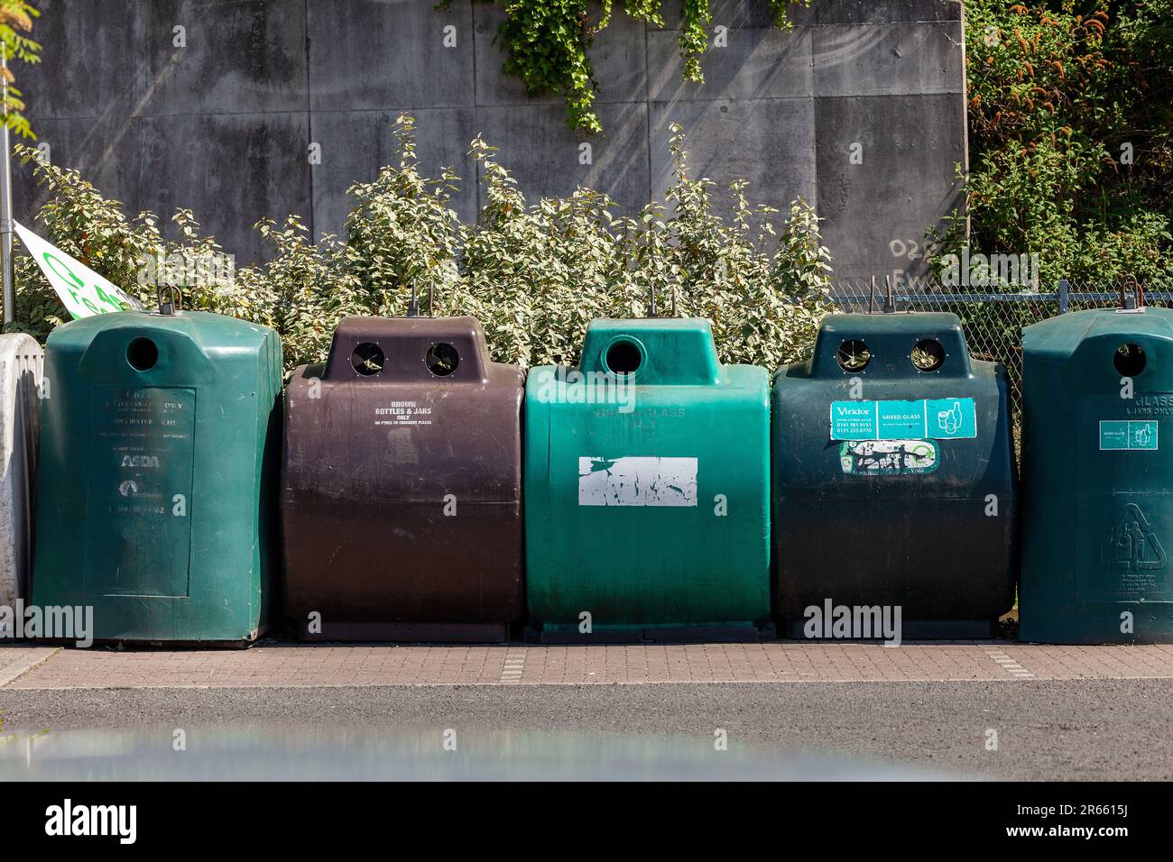 A row of glass recycling bins in a car park in Galashiels, Scotland