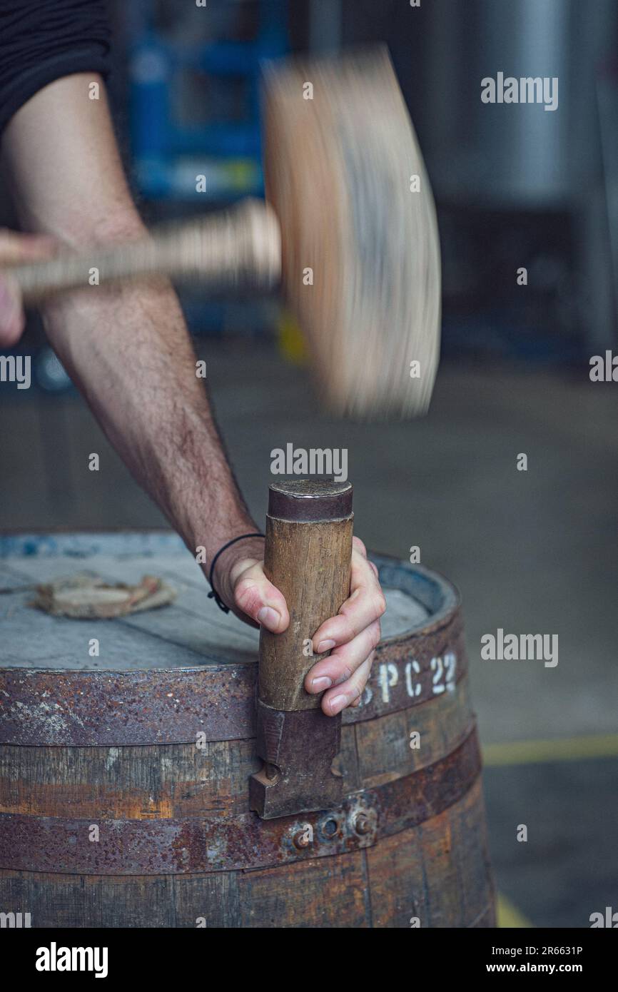 Hammer and chisel on whisky barrel Stock Photo