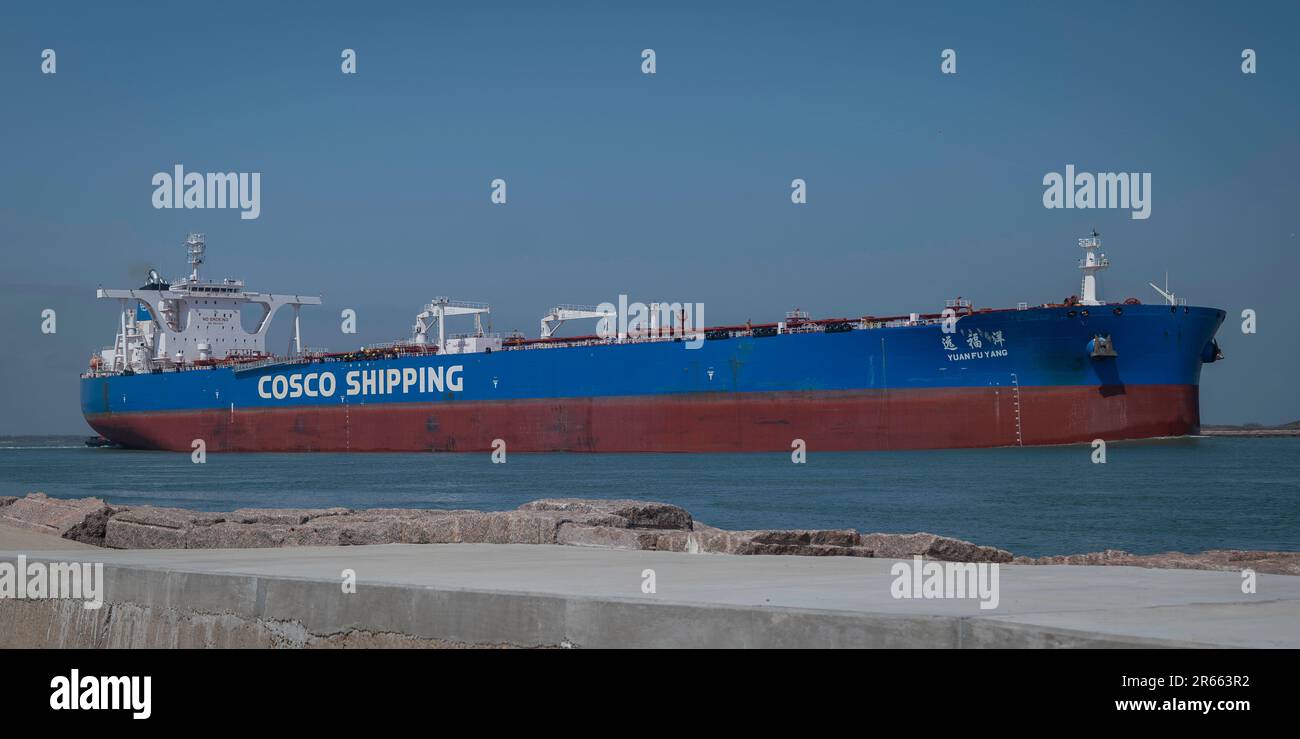 PORT ARANSAS, TX - 26 FEB 2023: The YUAN FU YANG, an Oil Products Tanker Ship sails toward the Gulf of Mexico by the South Jetty on the shipping chann Stock Photo