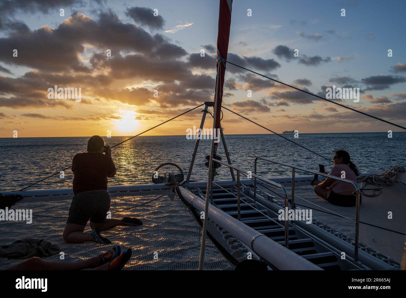 Bora Bora, French Polynesia--Feb 3, 2023. Tourists on a Catamran for a sunset cruise in the waters of Bora Bora. Stock Photo