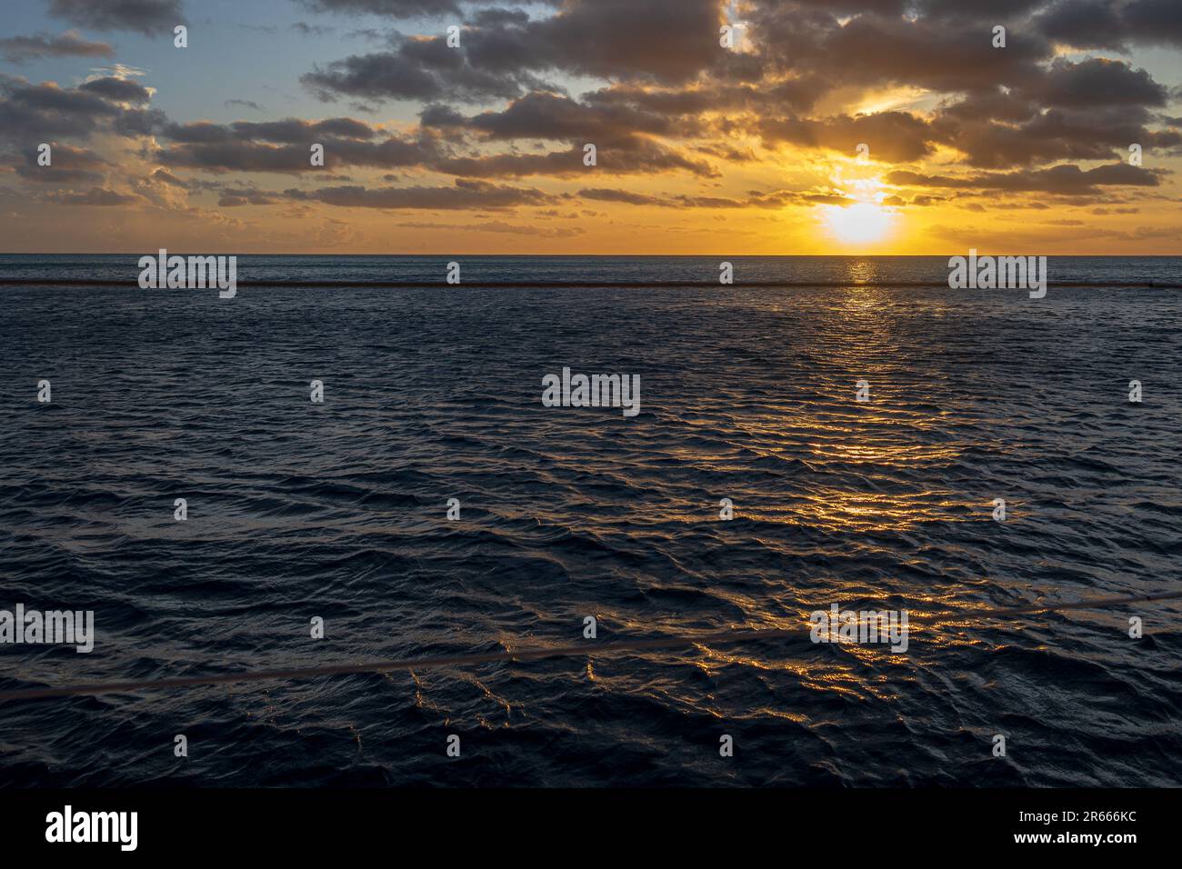Photo of a Sunset over the Pacific, taken from a Catamaran deck. Stock Photo