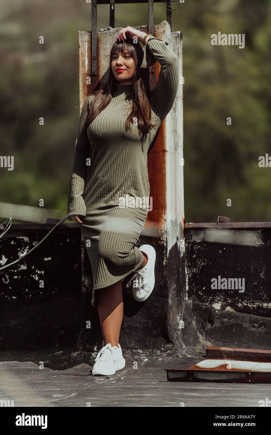 A confident and stylish plus-size woman walking by a modern building in an olive  green dress, radiating beauty, empowerment, and self-love Stock Photo -  Alamy