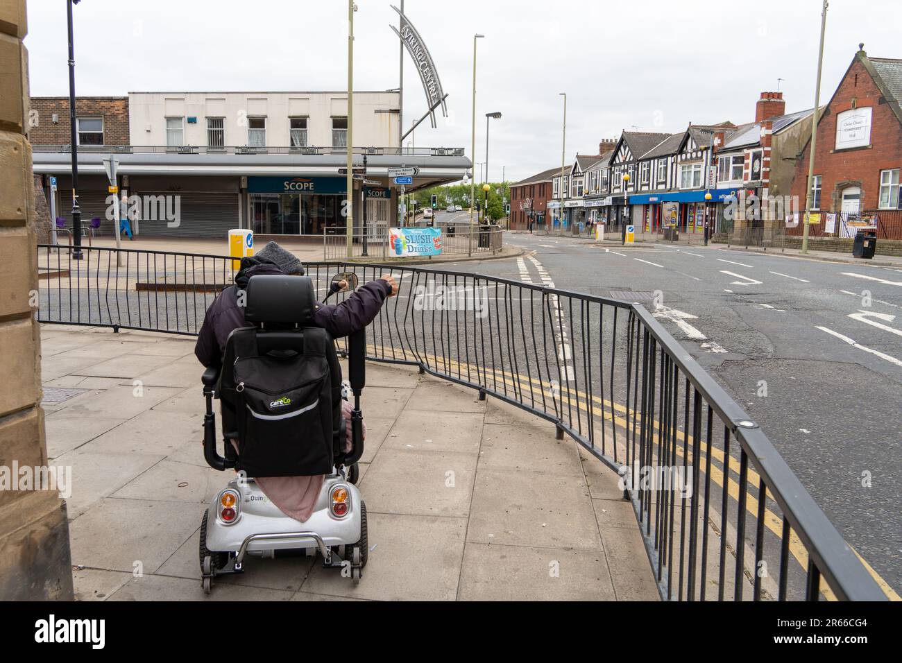 Jarrow, South Tyneside, UK. June 7th 2023. Trial of Universal Basic Income announced with Jarrow being one of the two towns in England where 15 people will be given £1,600 a month with no strings attached, to see what impact the money has on their lives. -- A man on a mobility scooter heads towards the Viking Shopping Centre in the town. Credit: Hazel Plater/ Alamy Live News Stock Photo