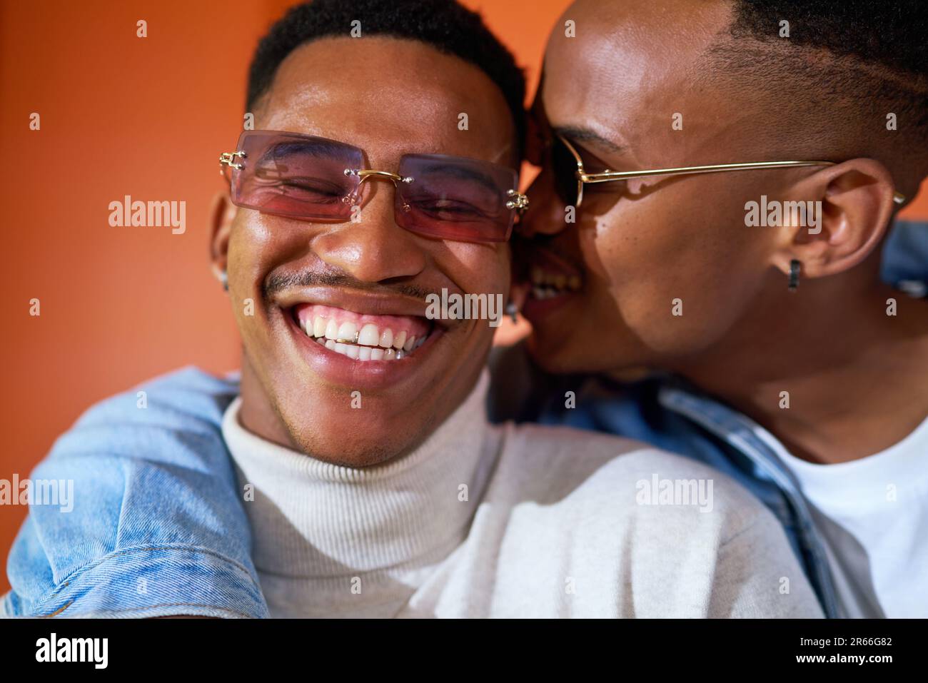 Close up portrait happy young gay male couple in sunglasses Stock Photo
