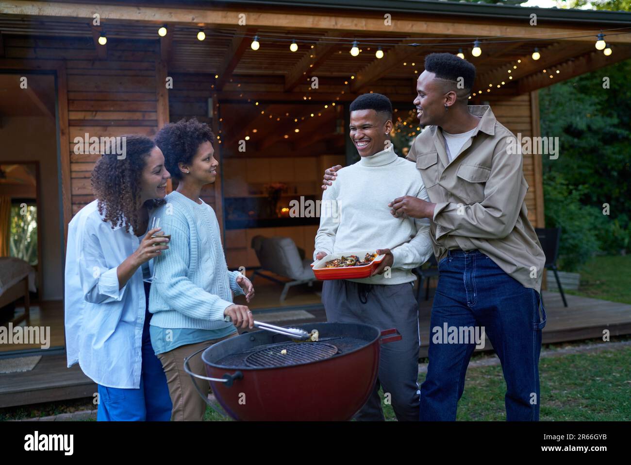 Gay couples bonding, enjoying barbecue in summer backyard Stock Photo