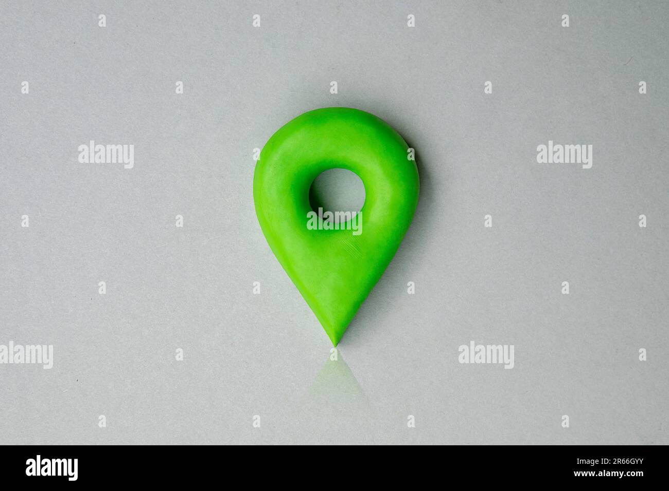 Green location symbol of pin on blue background, 3d GPS pin icon made of plasticine, location concept. Stock Photo