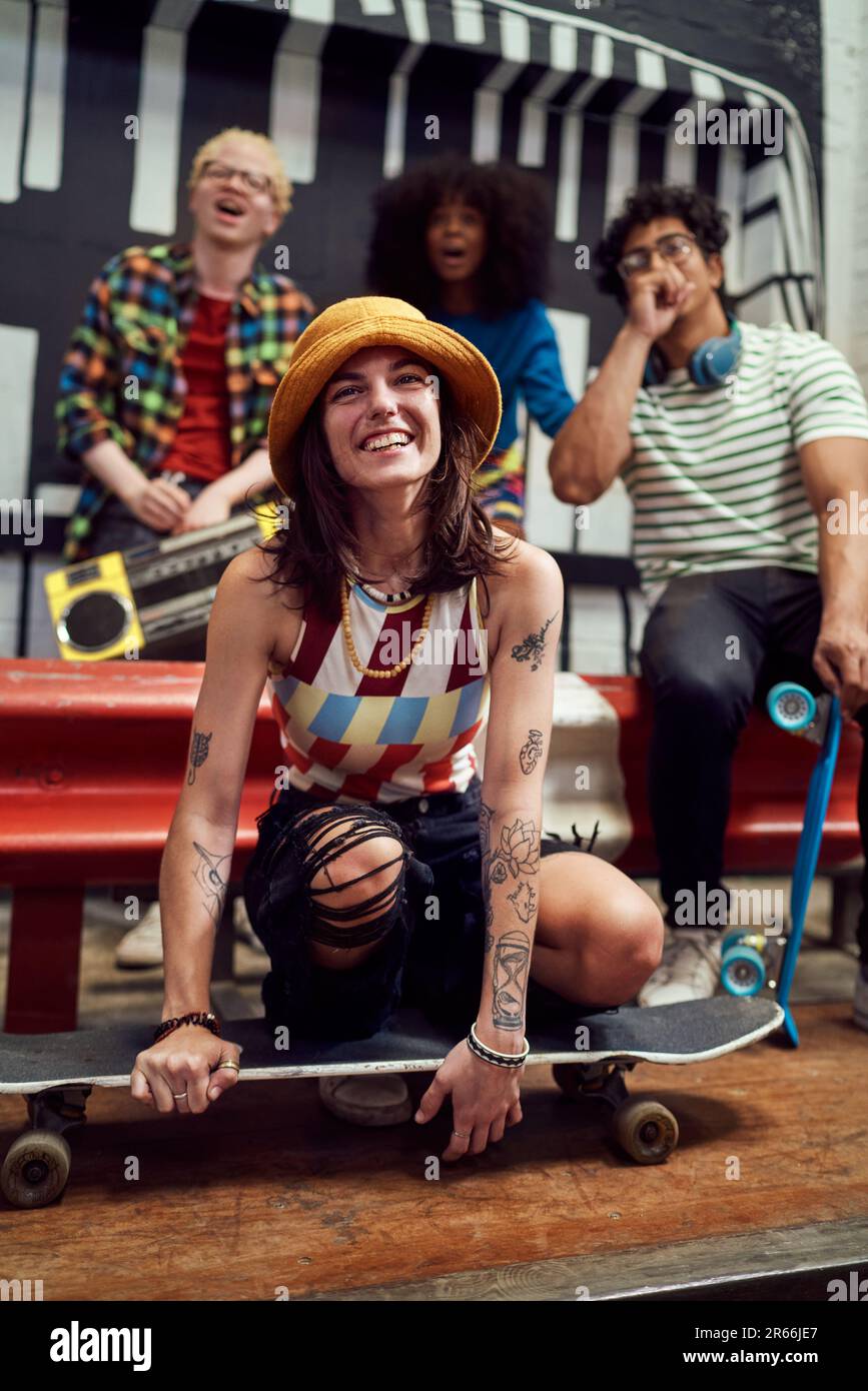 Portrait happy young friends with skateboard and boom box Stock Photo