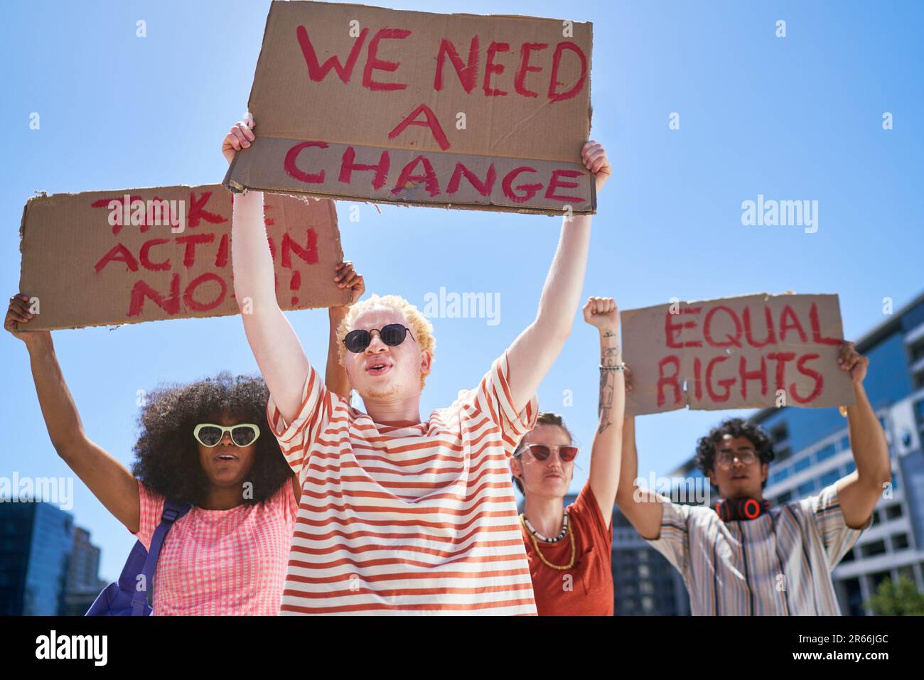 Young protester friends holding equal rights signs overhead Stock Photo