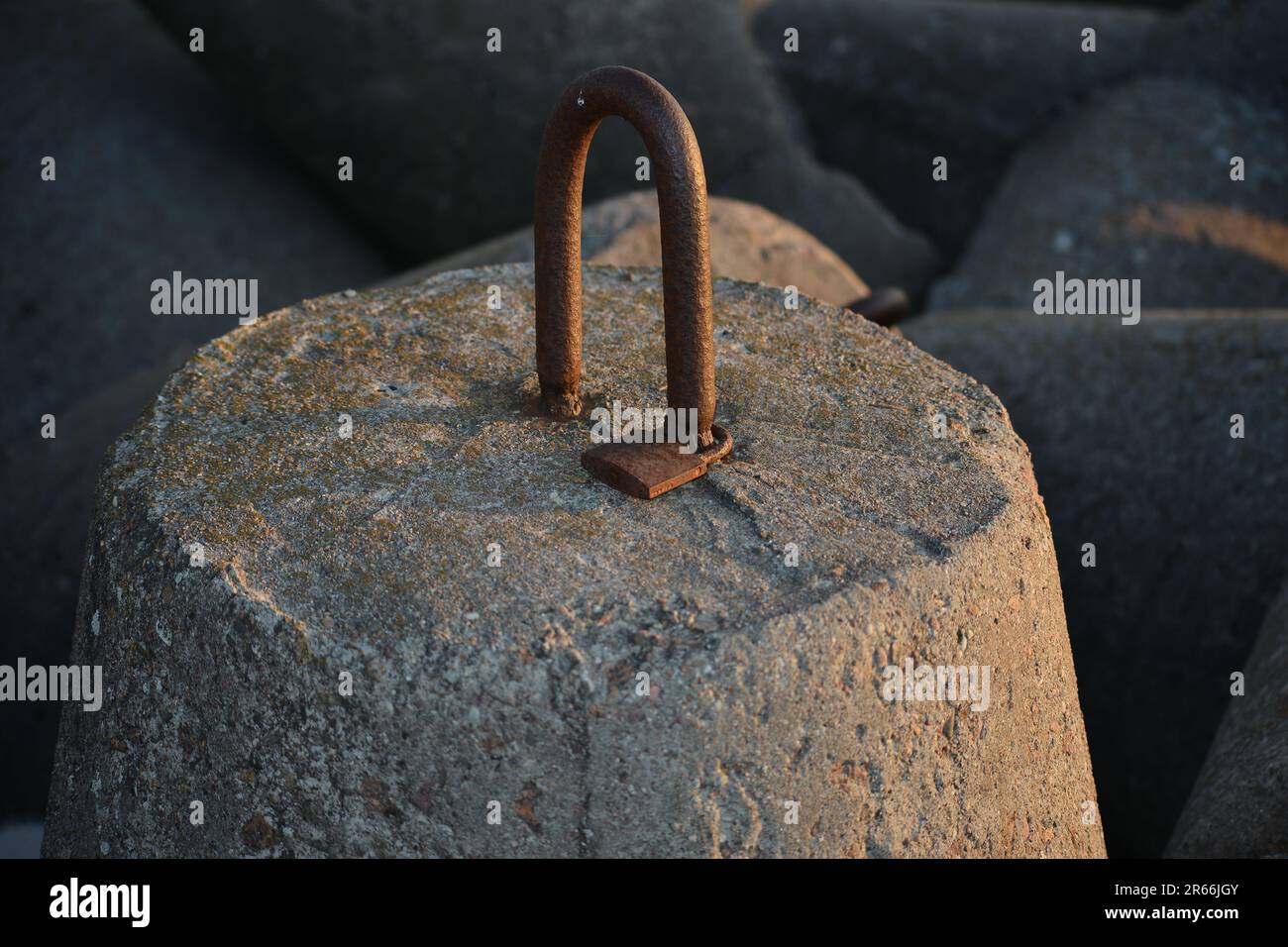 Concrete tetrapod with a padlock. Stock Photo