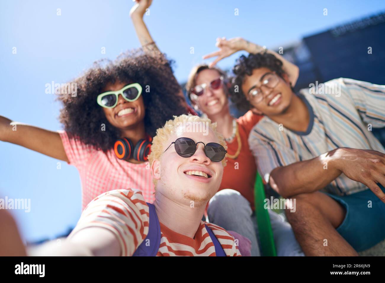 Selfie POV portrait happy young friends in sunny city Stock Photo