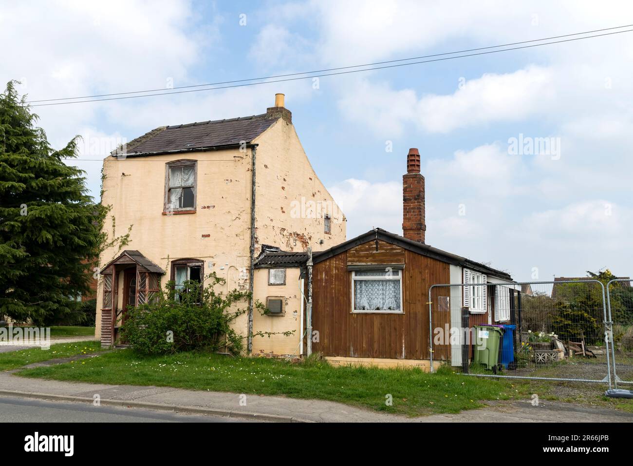 Old two up two down semidetached cottage with wood side extension