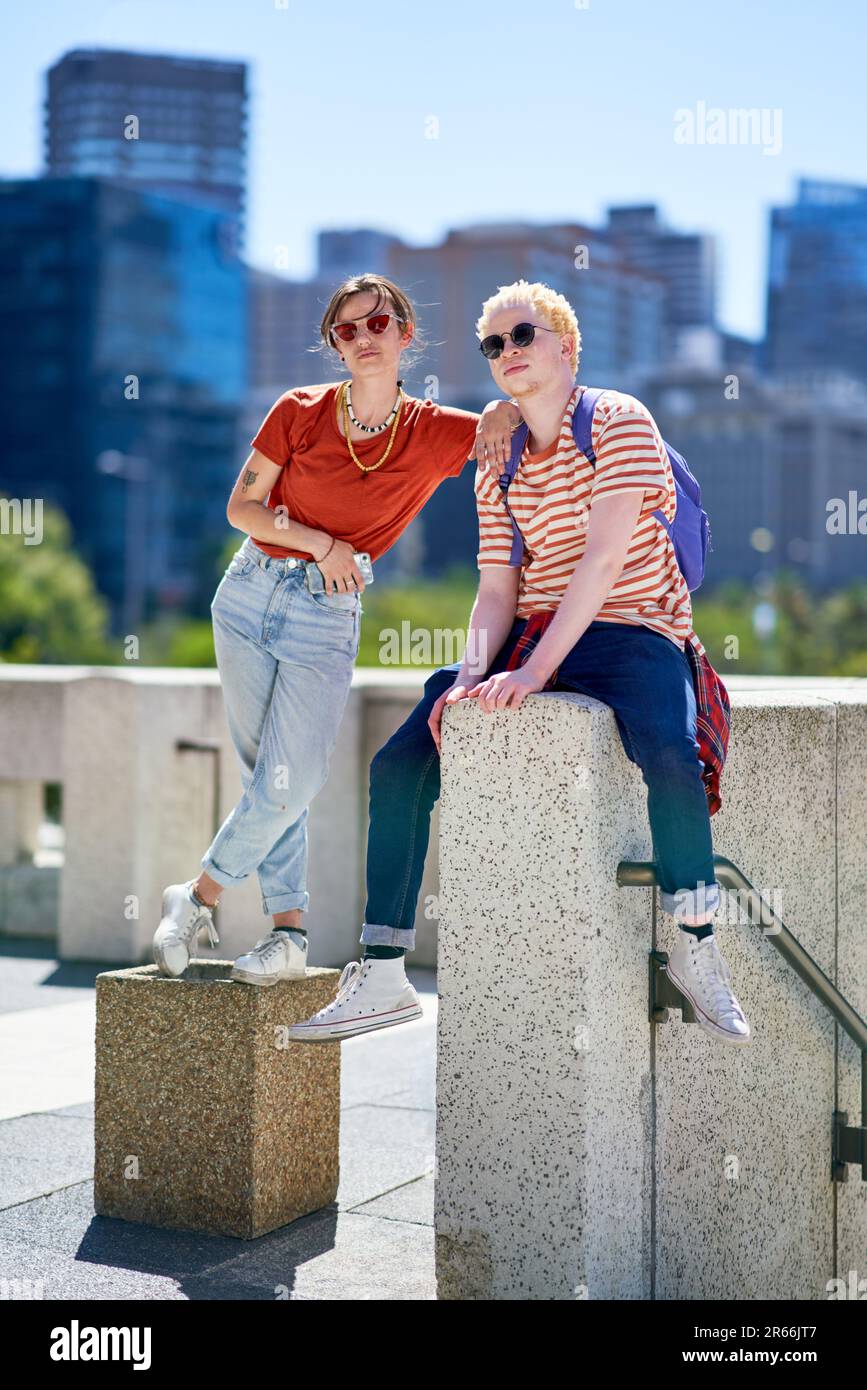 Portrait confident, cool young friends in sunny city Stock Photo