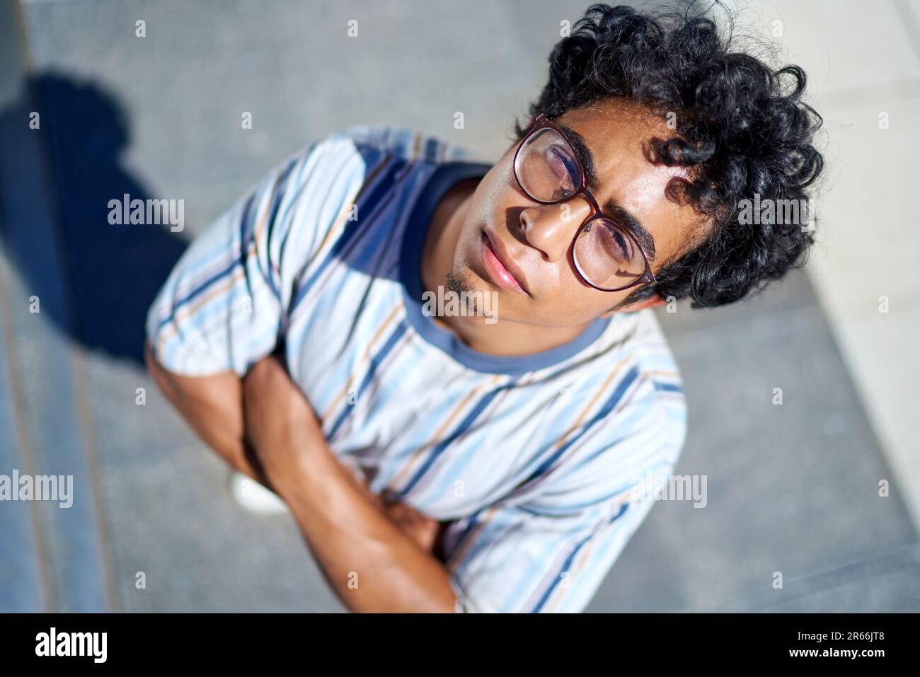 View from above portrait confident young man with arms crossed Stock Photo