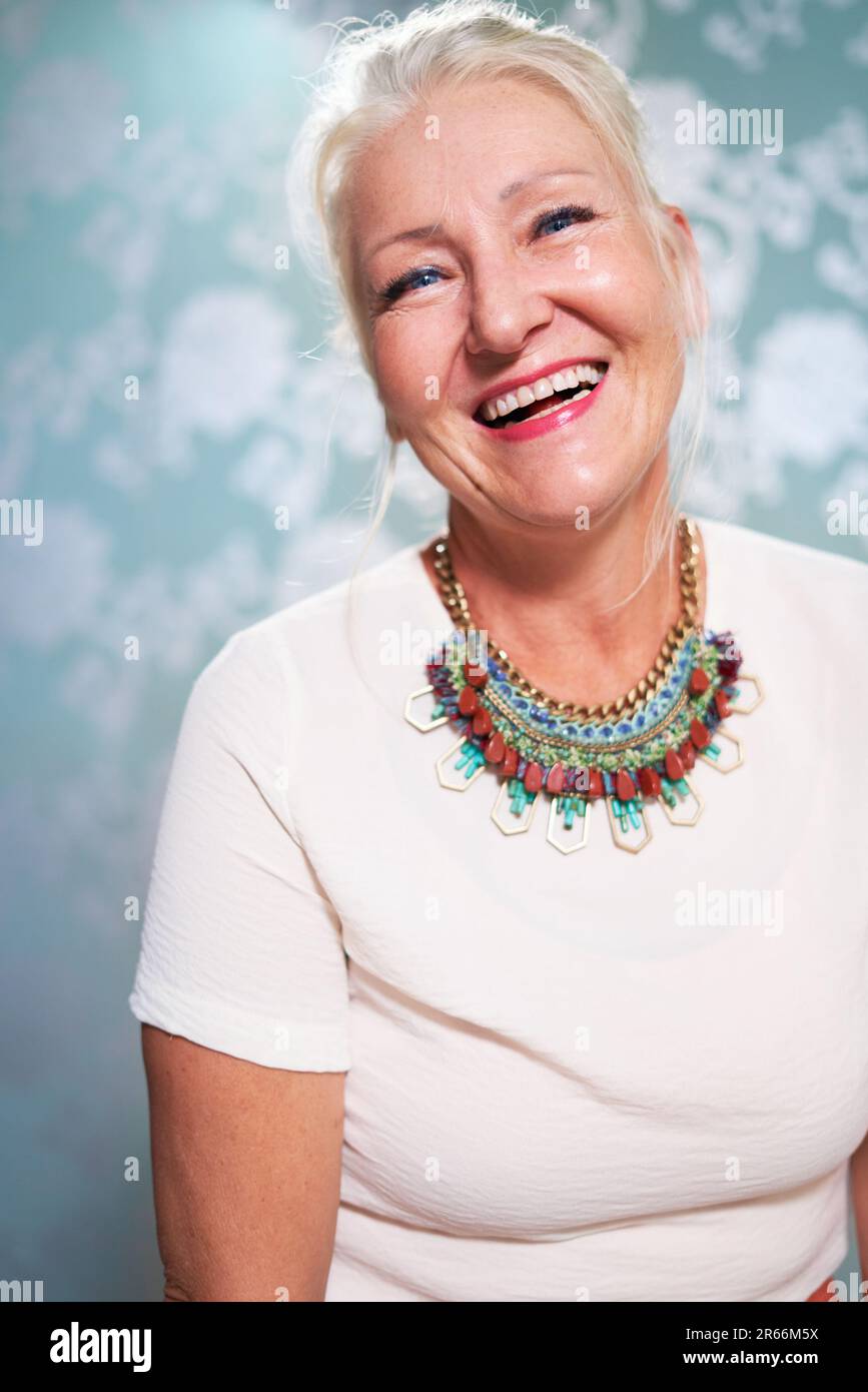 Portrait happy, beautiful senior woman wearing necklace Stock Photo