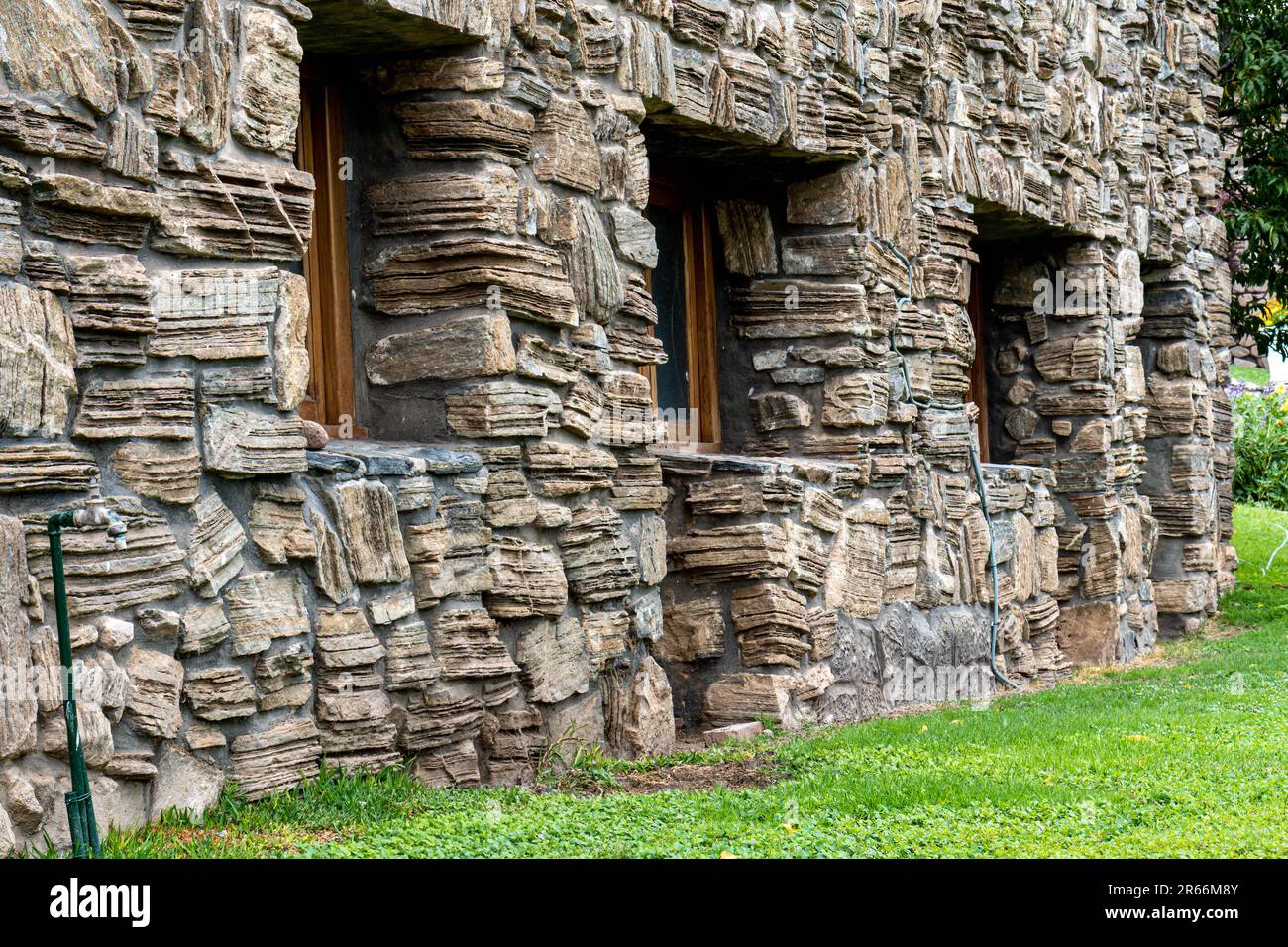 A high-resolution close-up shot of a building structure constructed of large,  rough-hewn stones Stock Photo