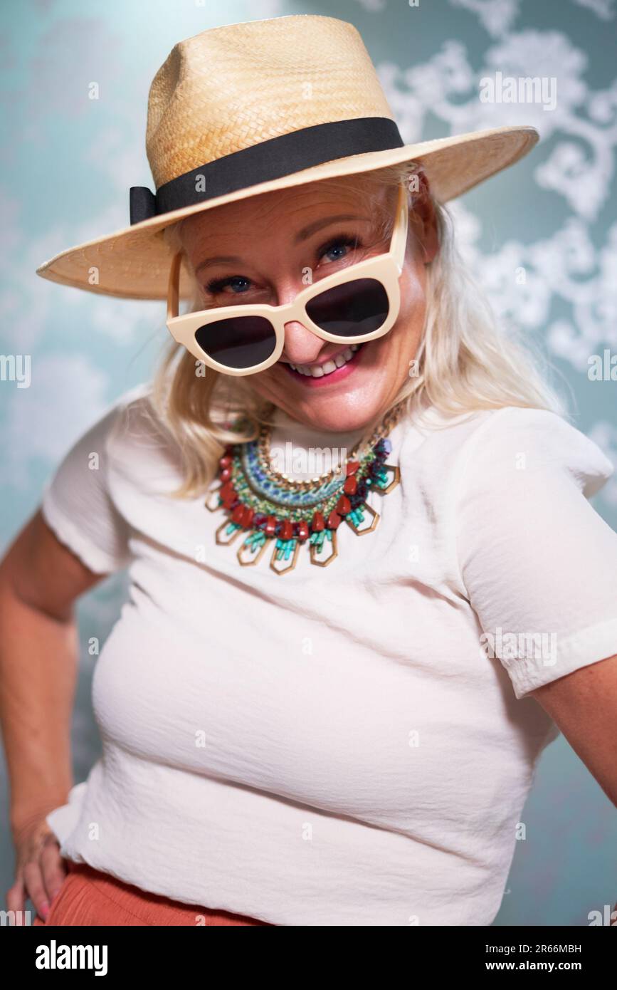 Portrait happy, playful senior woman in sunglasses and hat Stock Photo