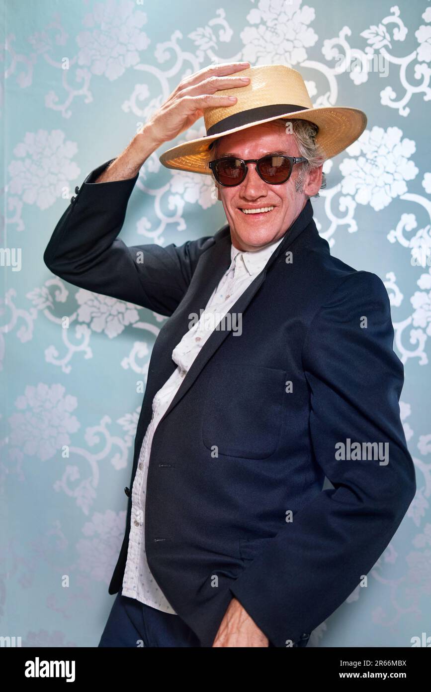 Portrait carefree, stylish senior man in hat and sunglasses Stock Photo