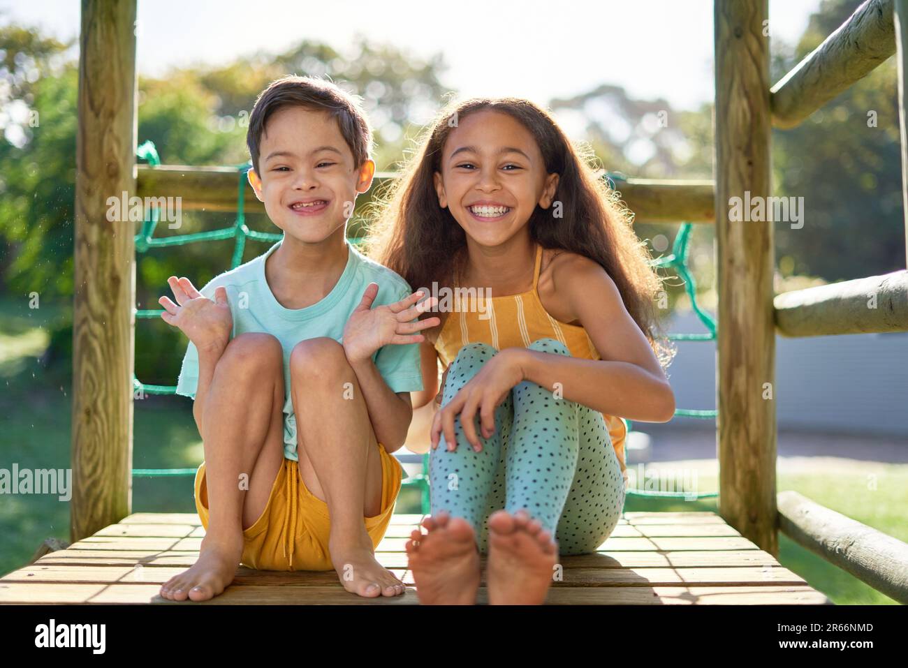 Portrait happy sister and brother with Down Syndrome at playground Stock Photo