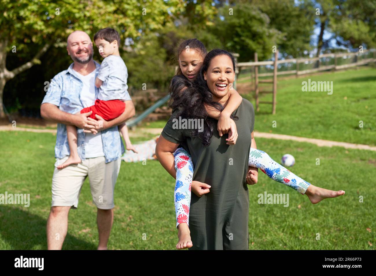 Portrait happy, carefree family in sunny summer park Stock Photo