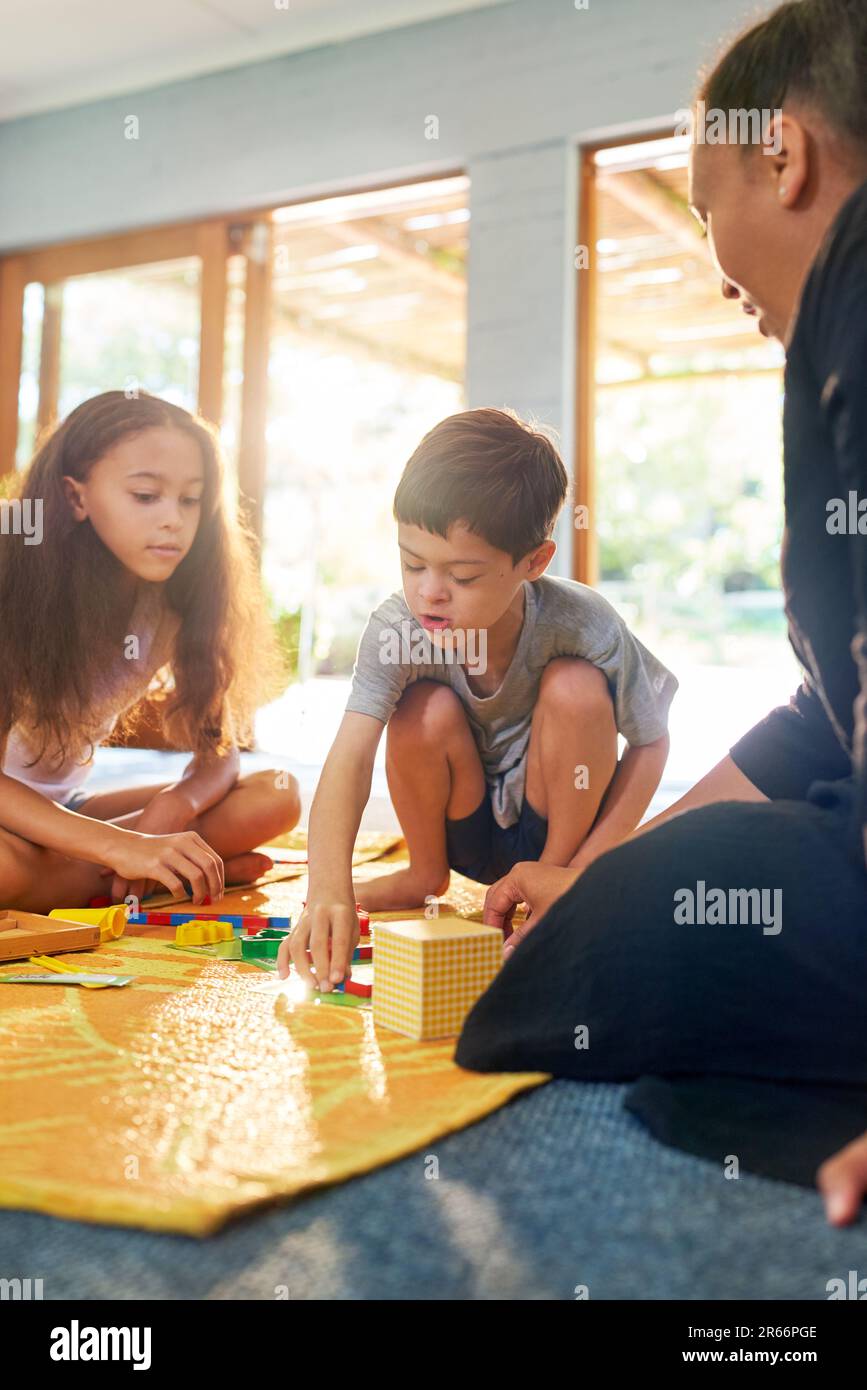 Family playing with toys on mat at home Stock Photo