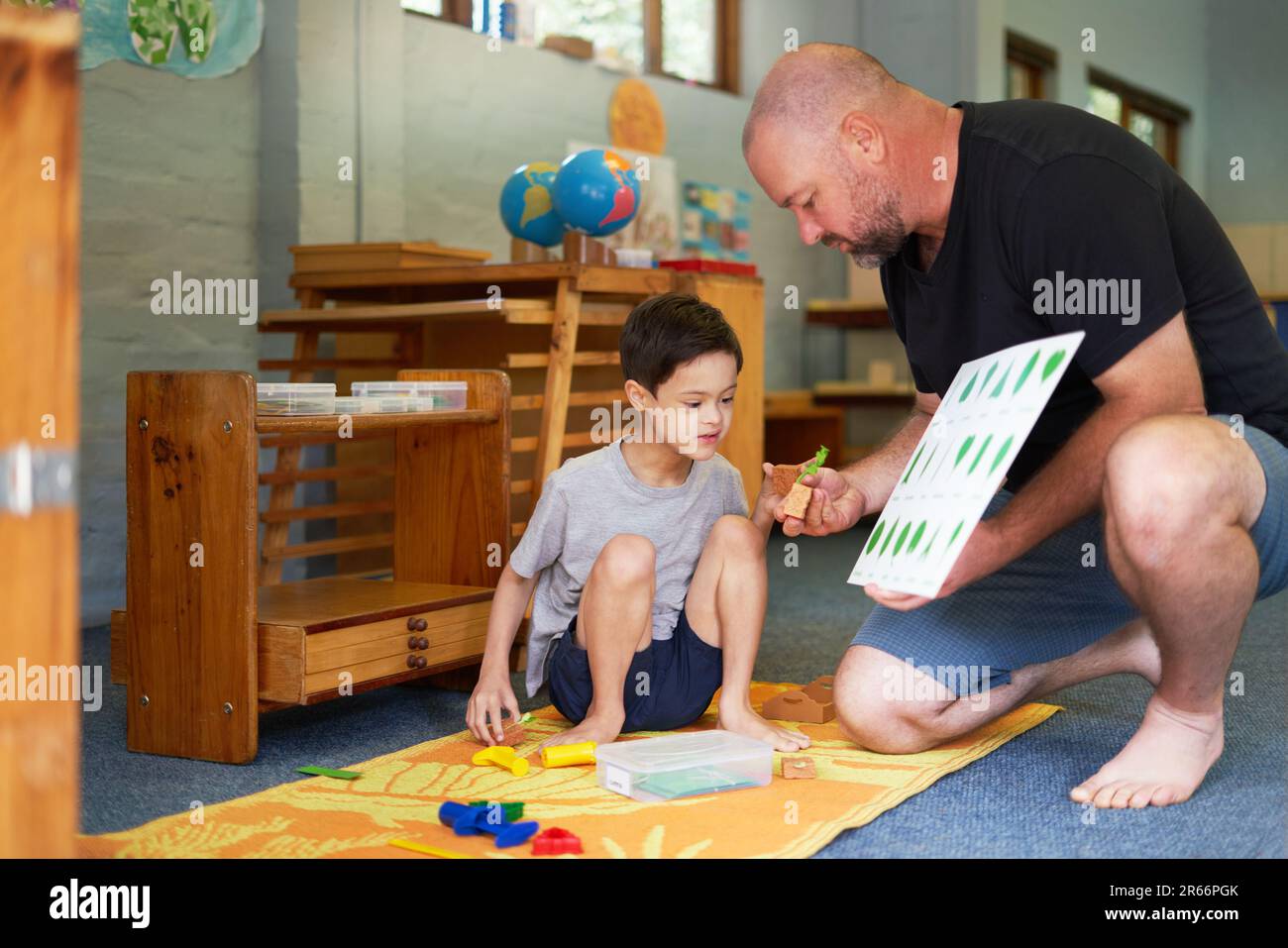 Father and son with Down Syndrome learning about plants Stock Photo