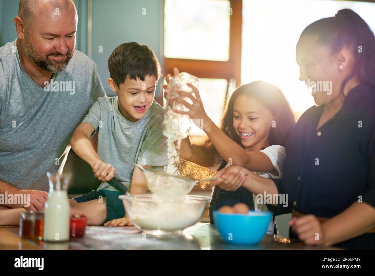 Happy family baking together in kitchen at home Stock Photo