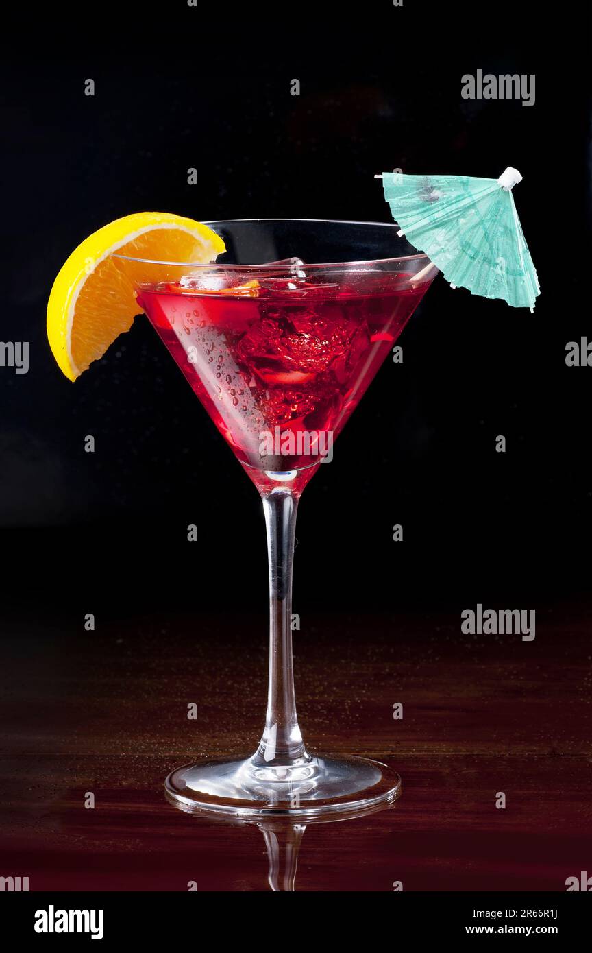 Sea Breeze cocktail in martini glass against black background Stock Photo