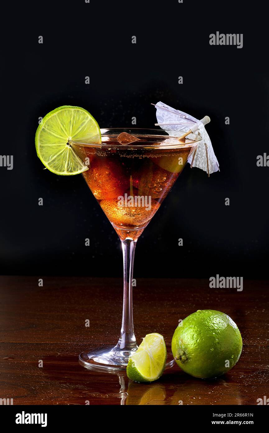 Bermuda black cocktail in martini glass against black background Stock Photo