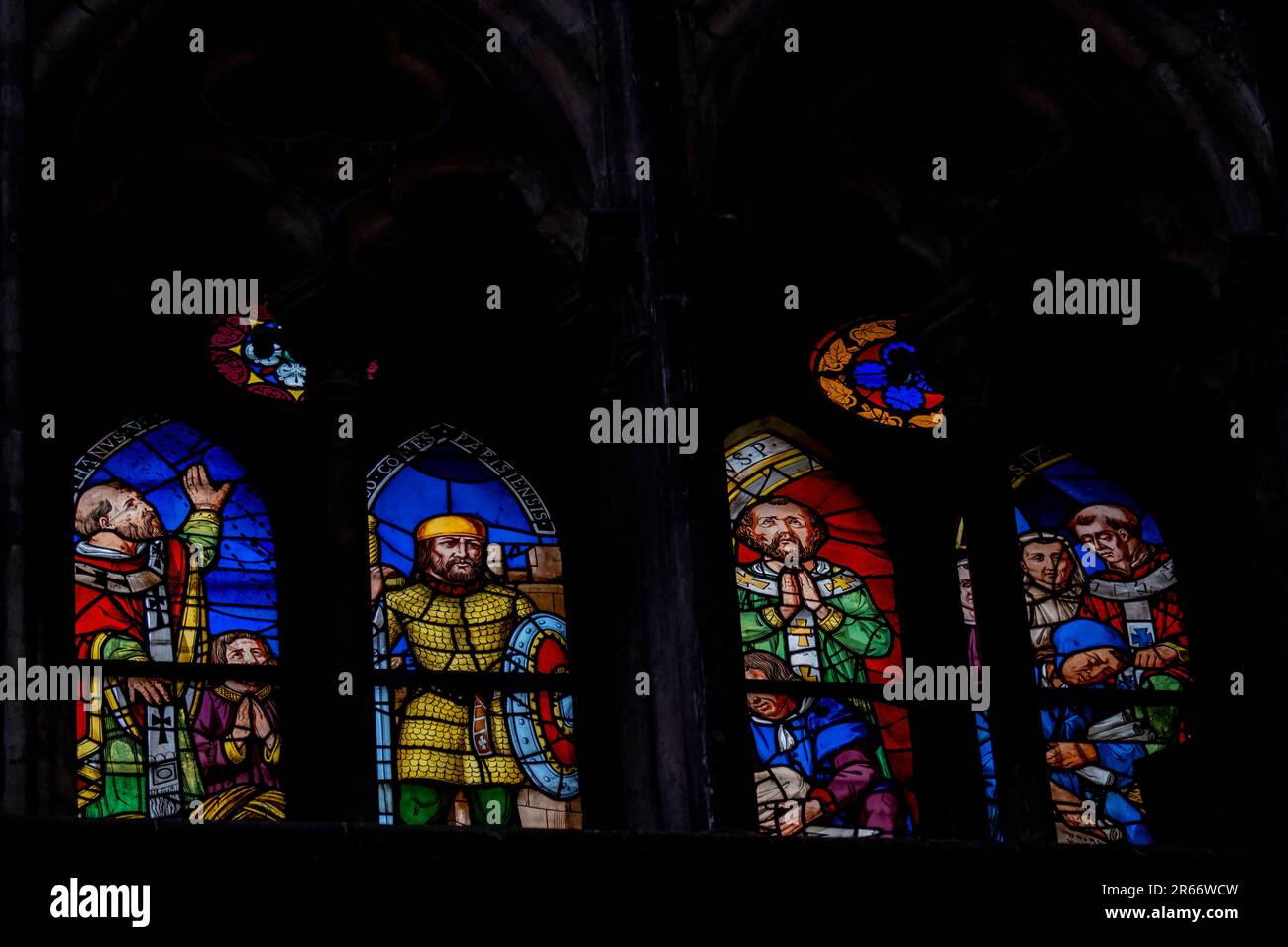 Multi colored medieval era stained glass panels depicting clergy