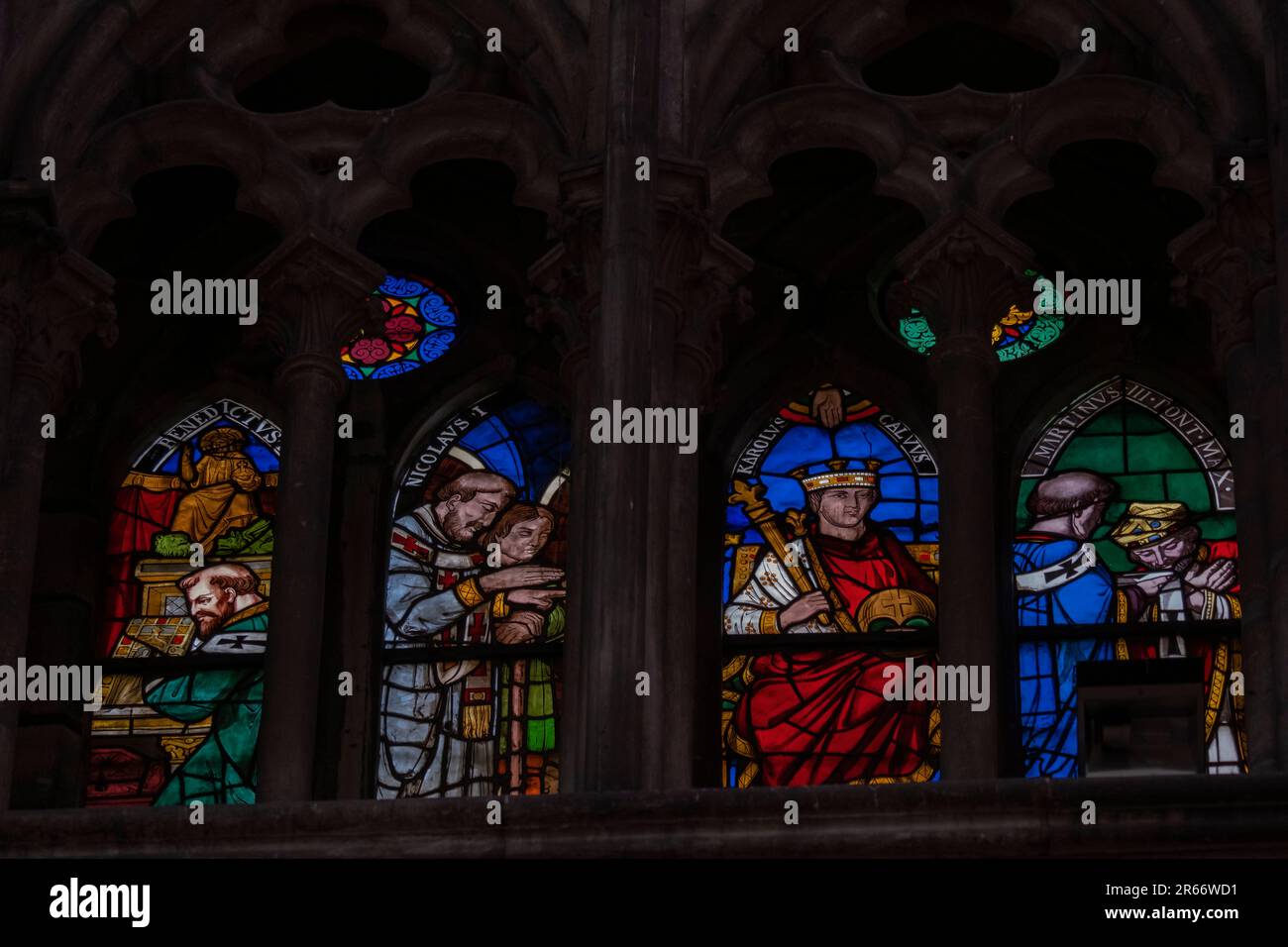 Multi colored medieval era stained glass panels depicting clergy
