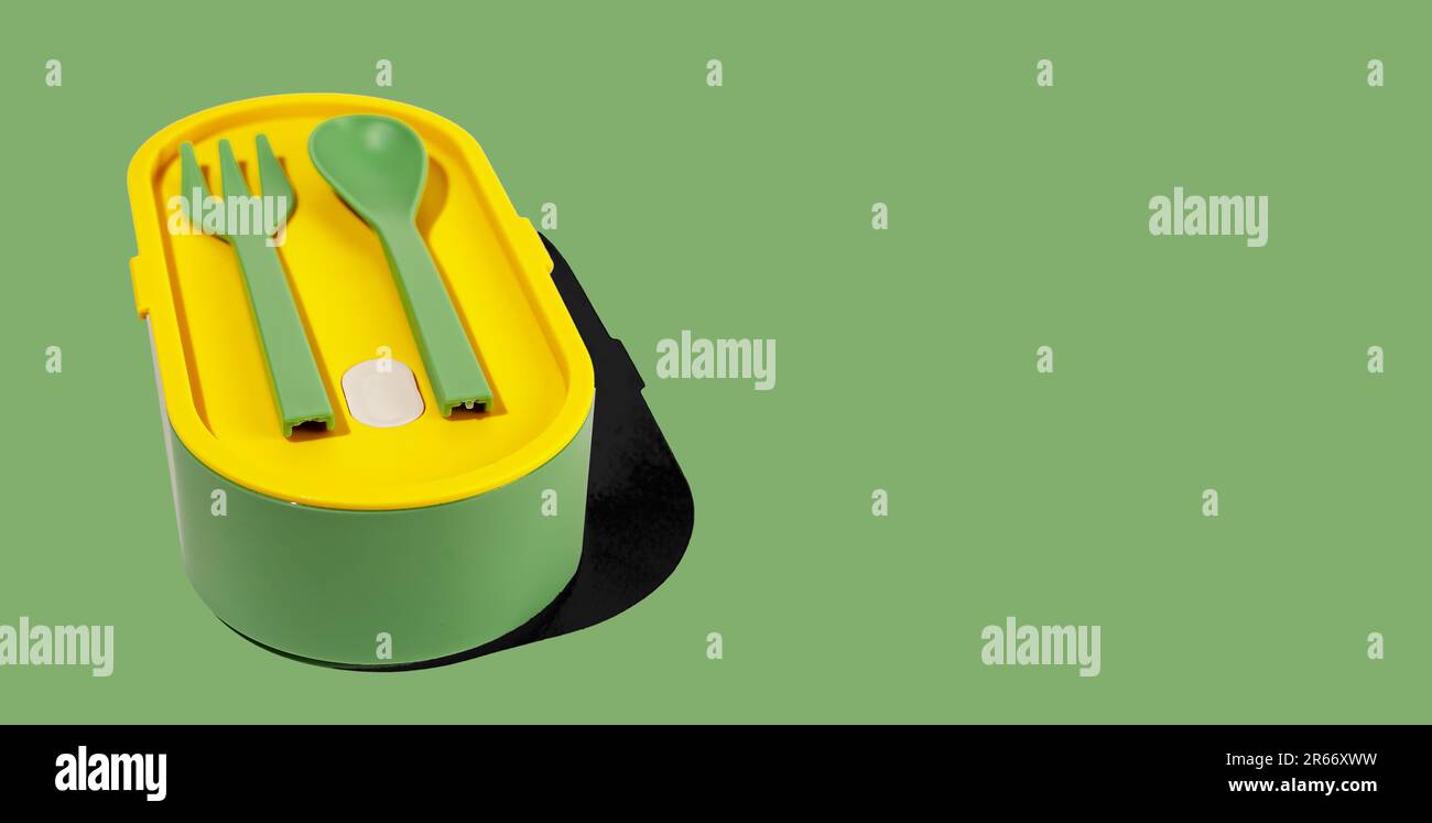 Lunch box and plastic fork, spoon, utensils. Green lunchbox container