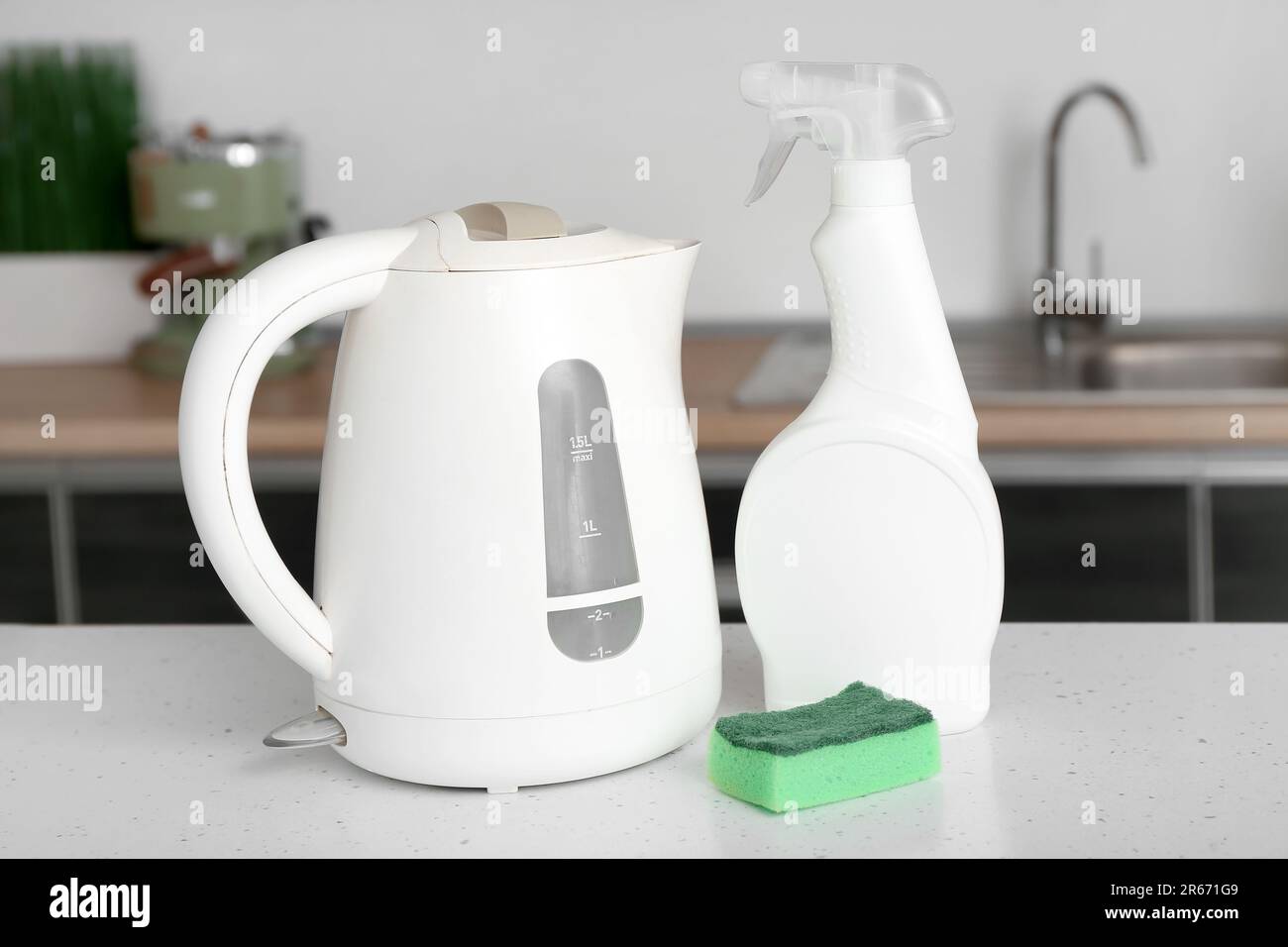 https://c8.alamy.com/comp/2R671G9/electric-kettle-spray-bottle-with-detergent-and-sponge-on-table-in-kitchen-2R671G9.jpg